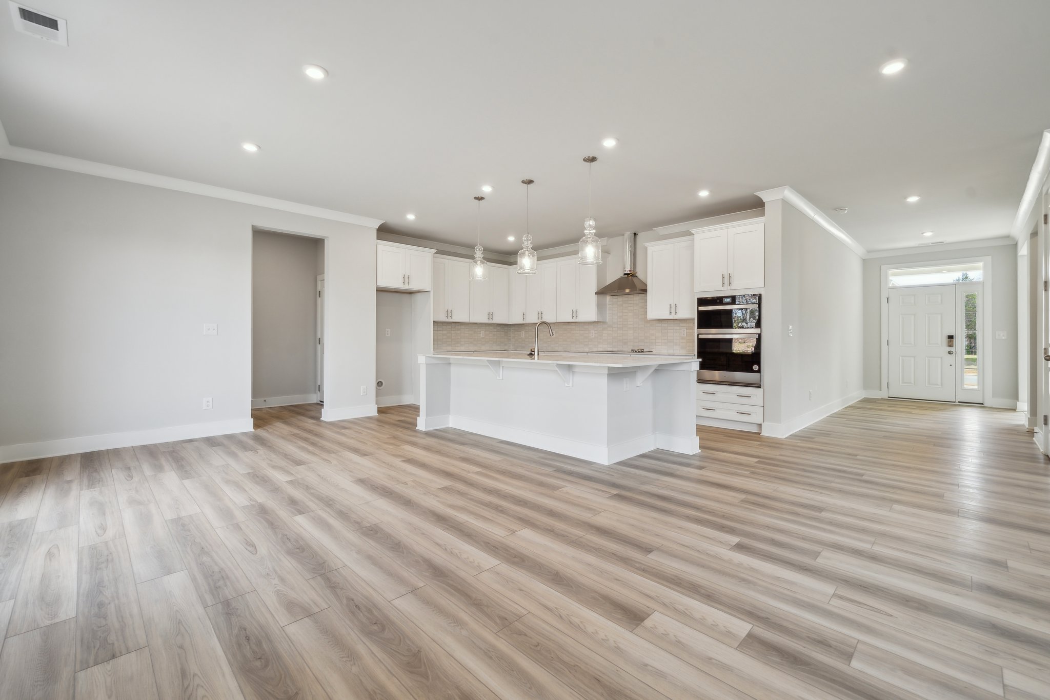 A large kitchen with white cabinets.