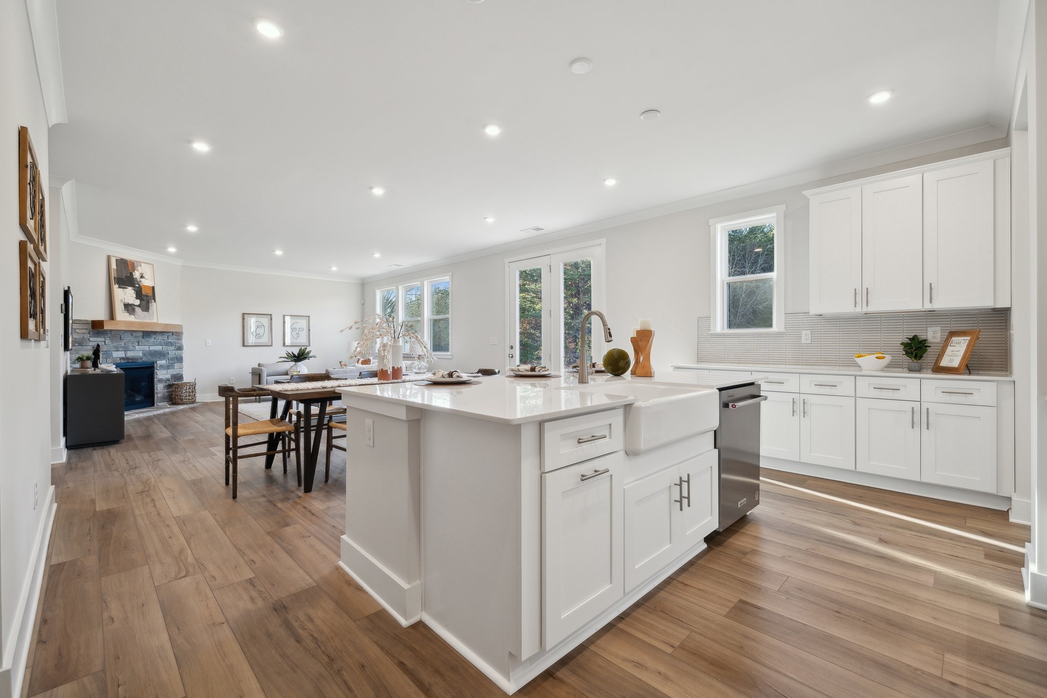 A kitchen with white cabinets.