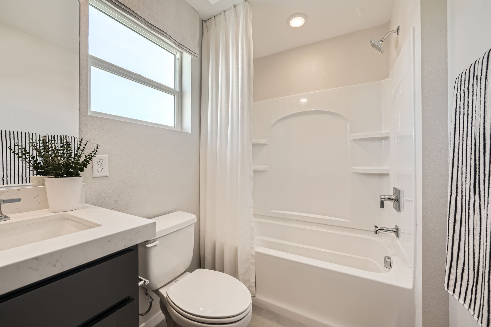 A bathroom with a tub toilet and sink.