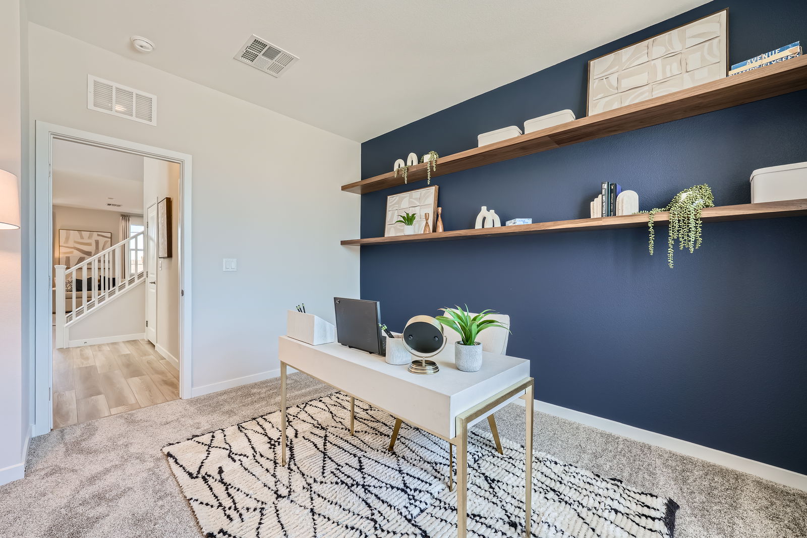 A room with a desk and shelves.