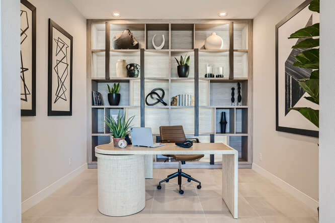 A desk with a laptop on it.