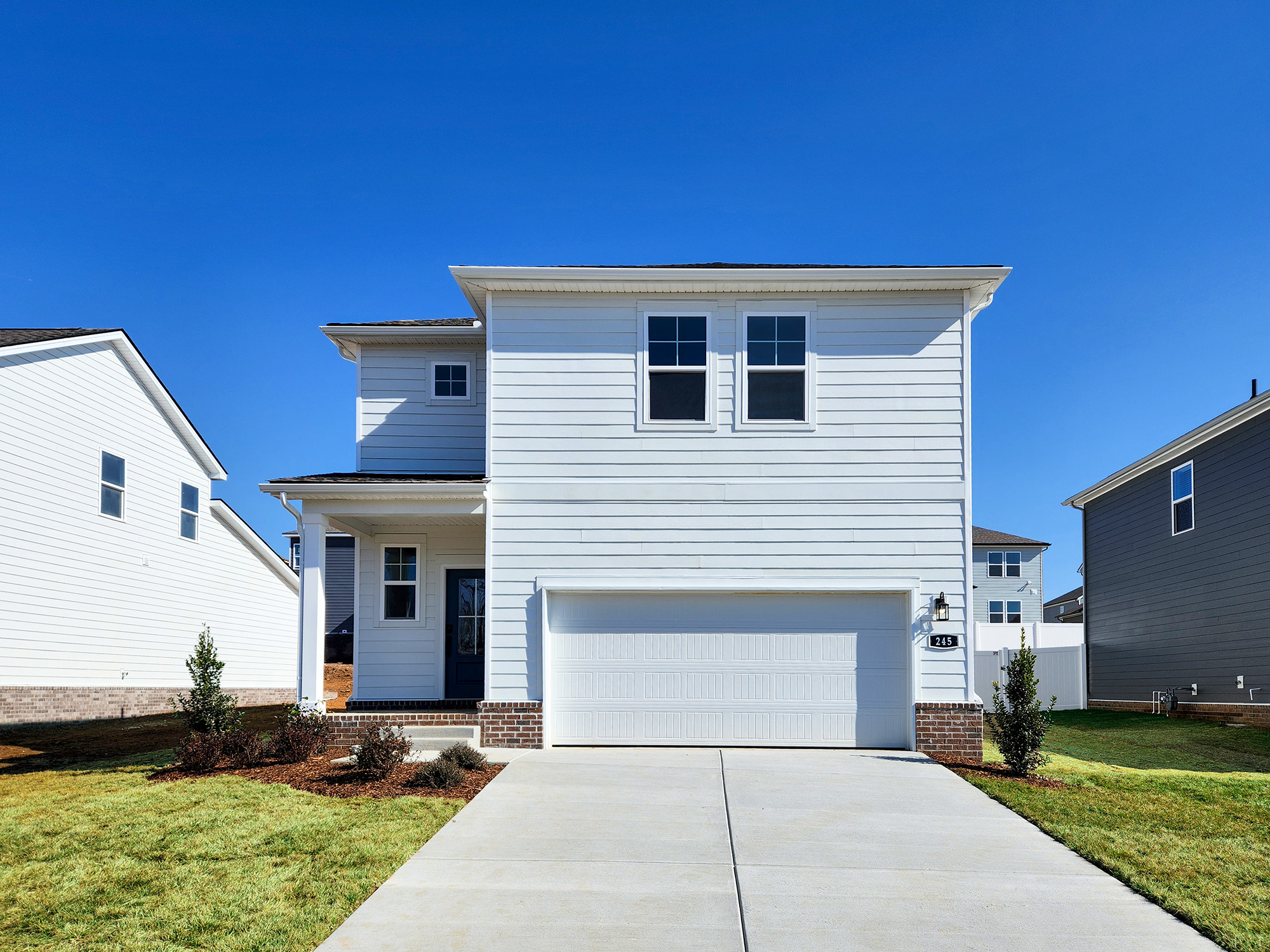 A white house with a garage.