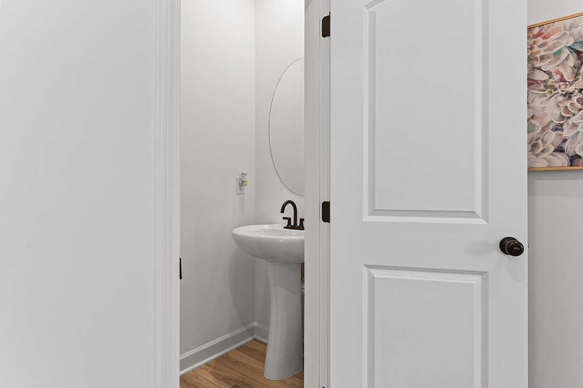 A bathroom with a sink and a mirror.