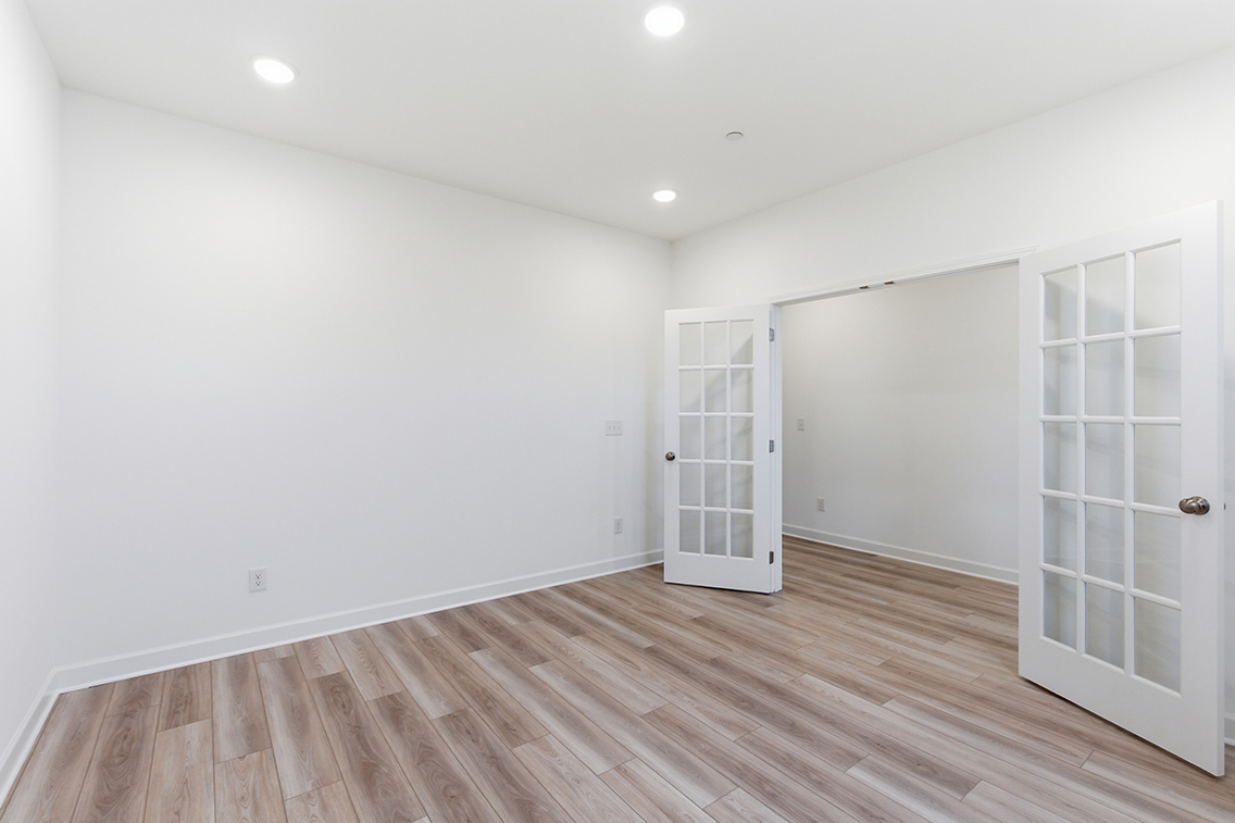 A room with white walls and a wood floor.