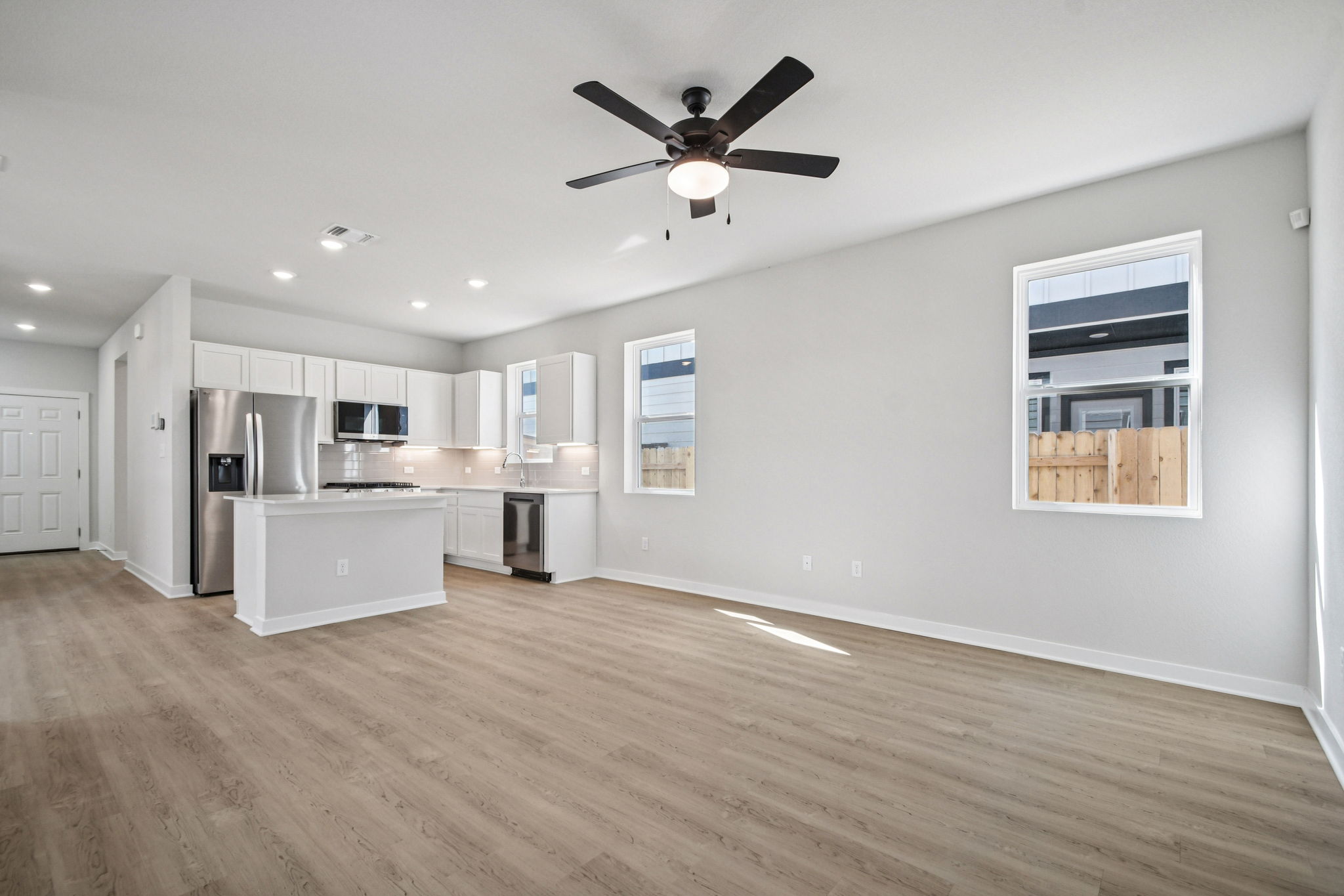 A kitchen with white cabinets.