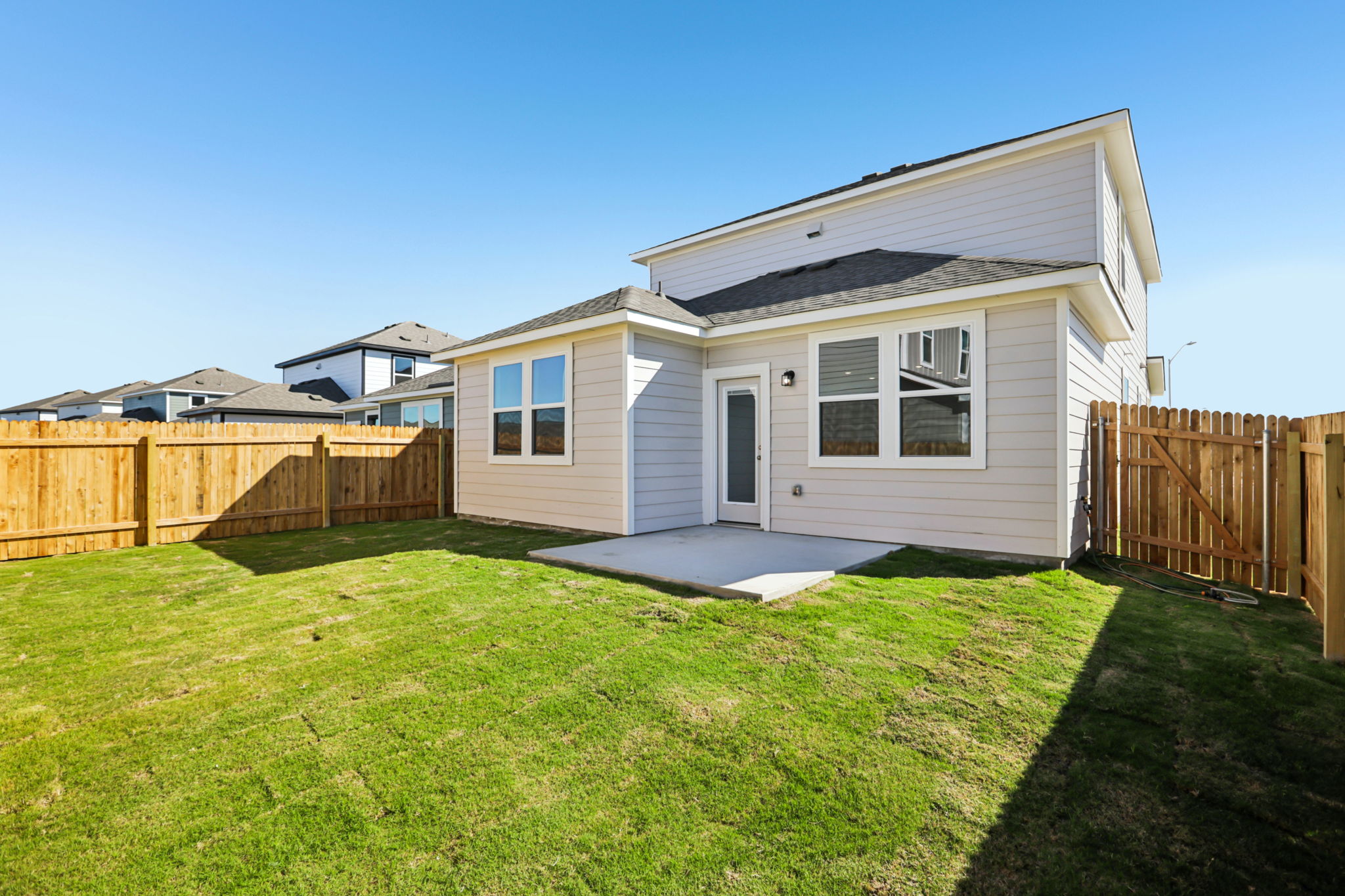 A house with a fence and grass.