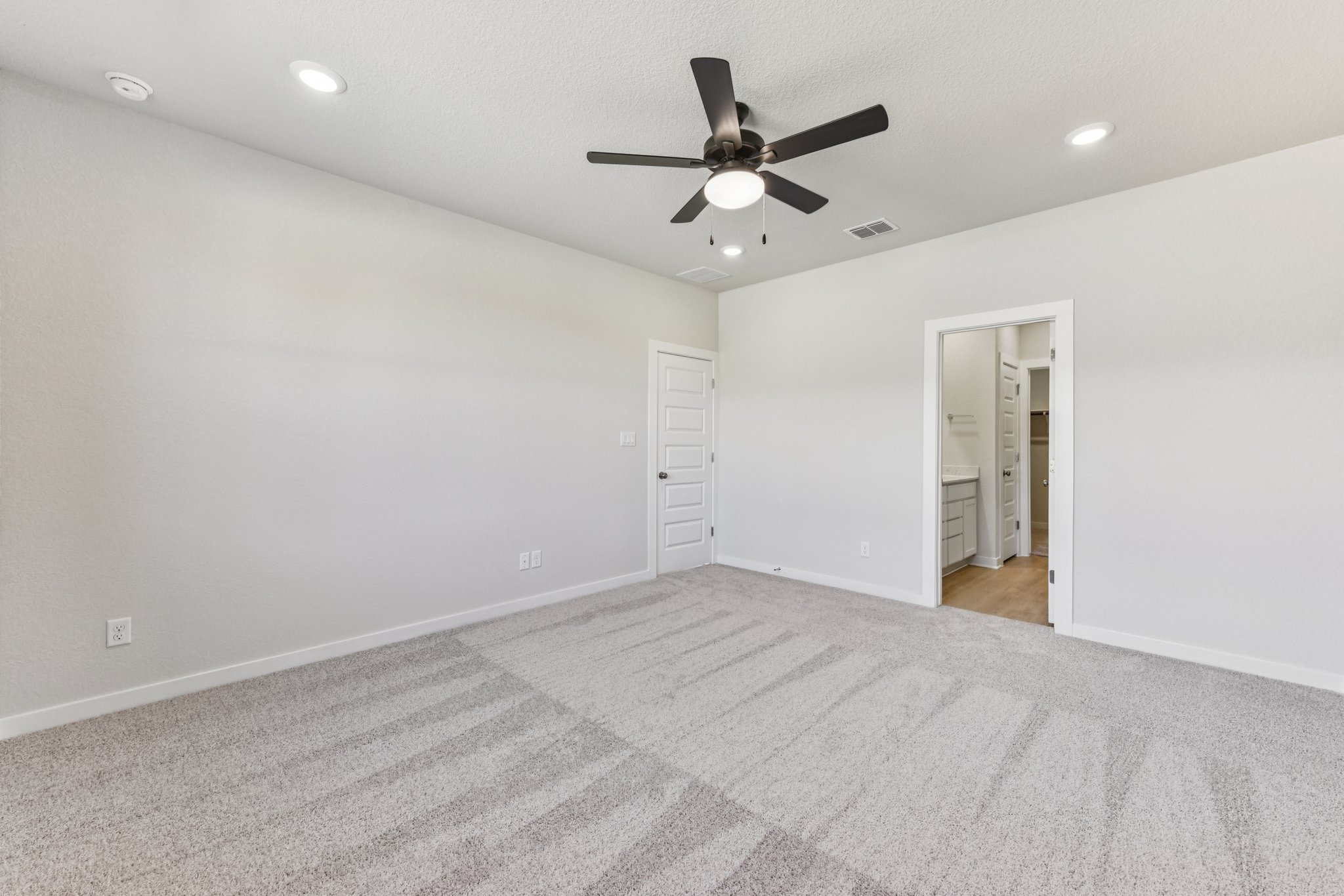 A room with a ceiling fan and a ceiling fan.