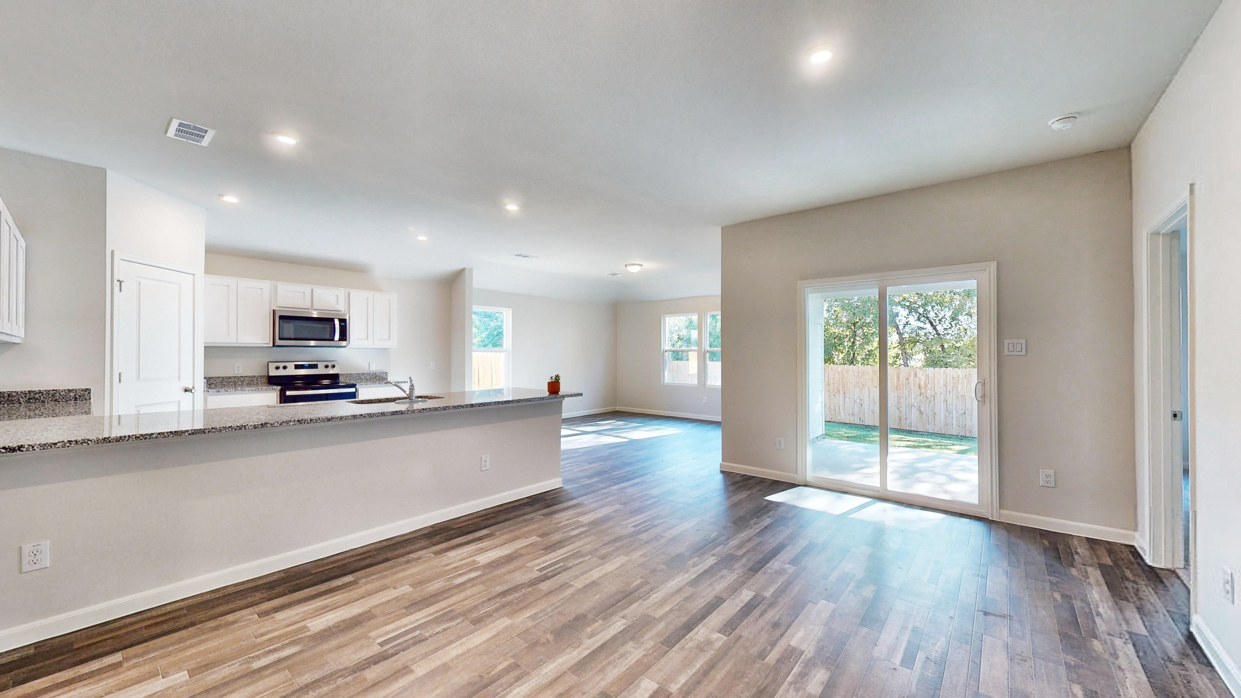 A large kitchen with a large wooden floor.