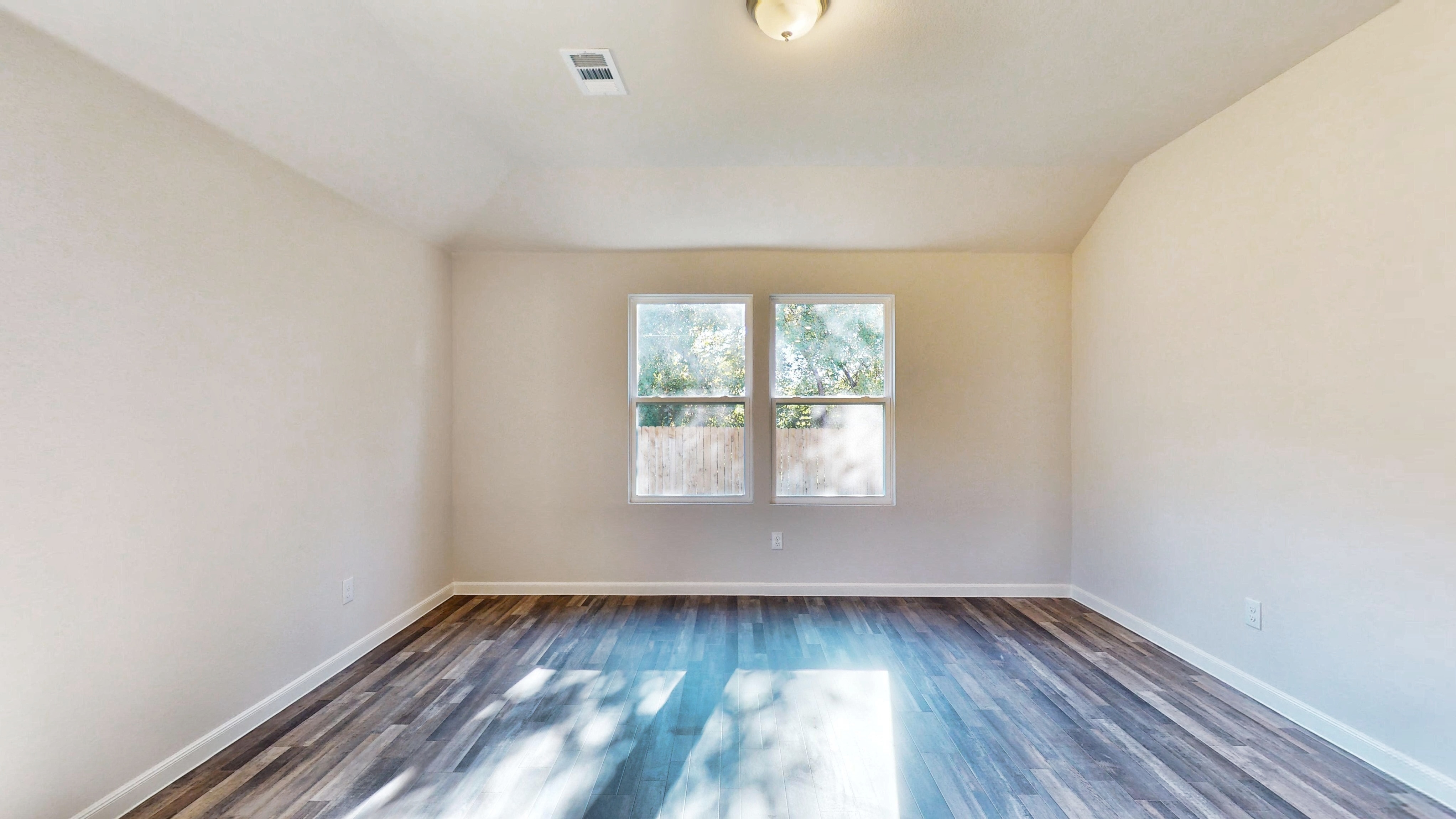 A room with a blue floor and windows.