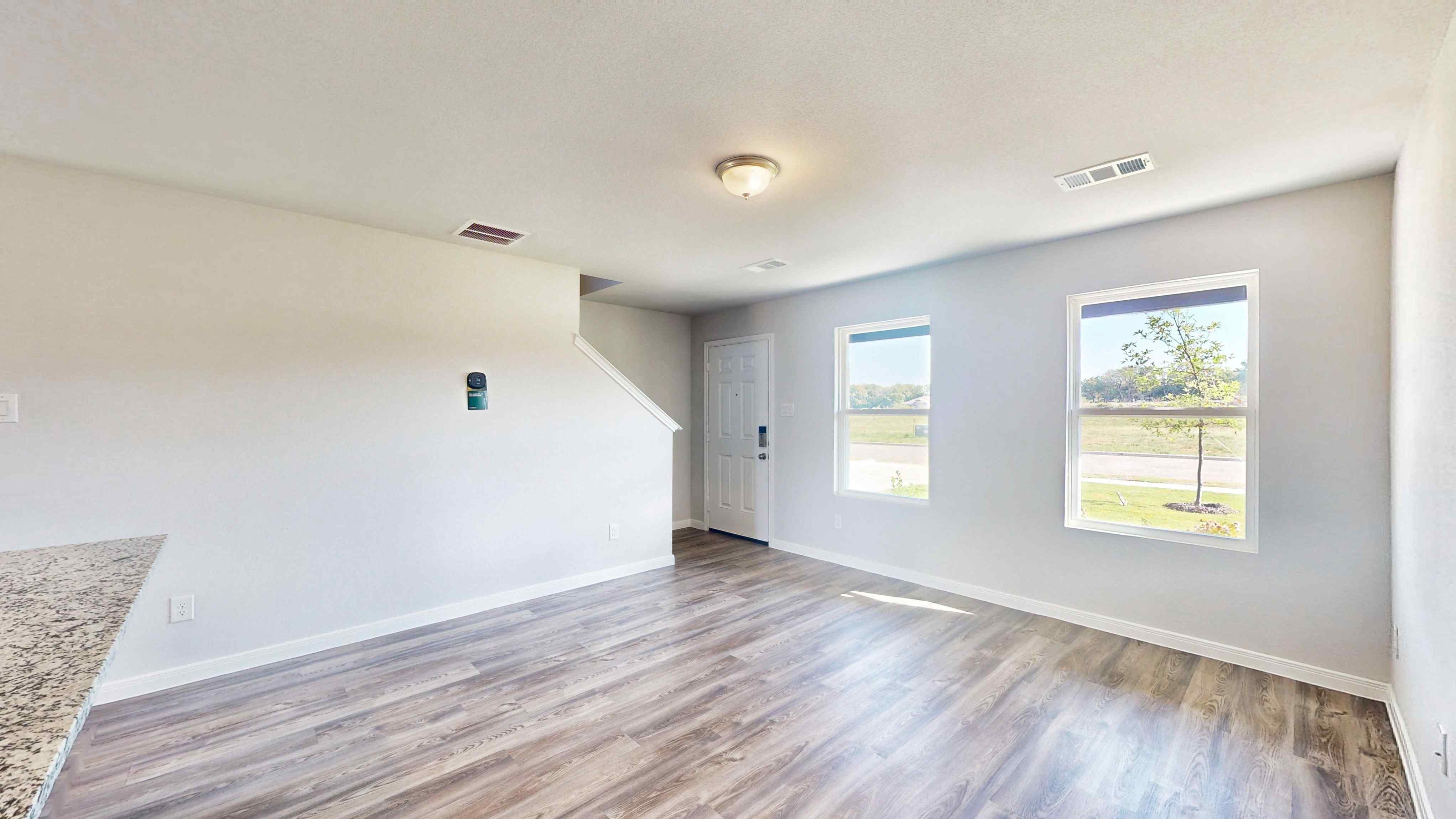 A room with a wood floor and a window.