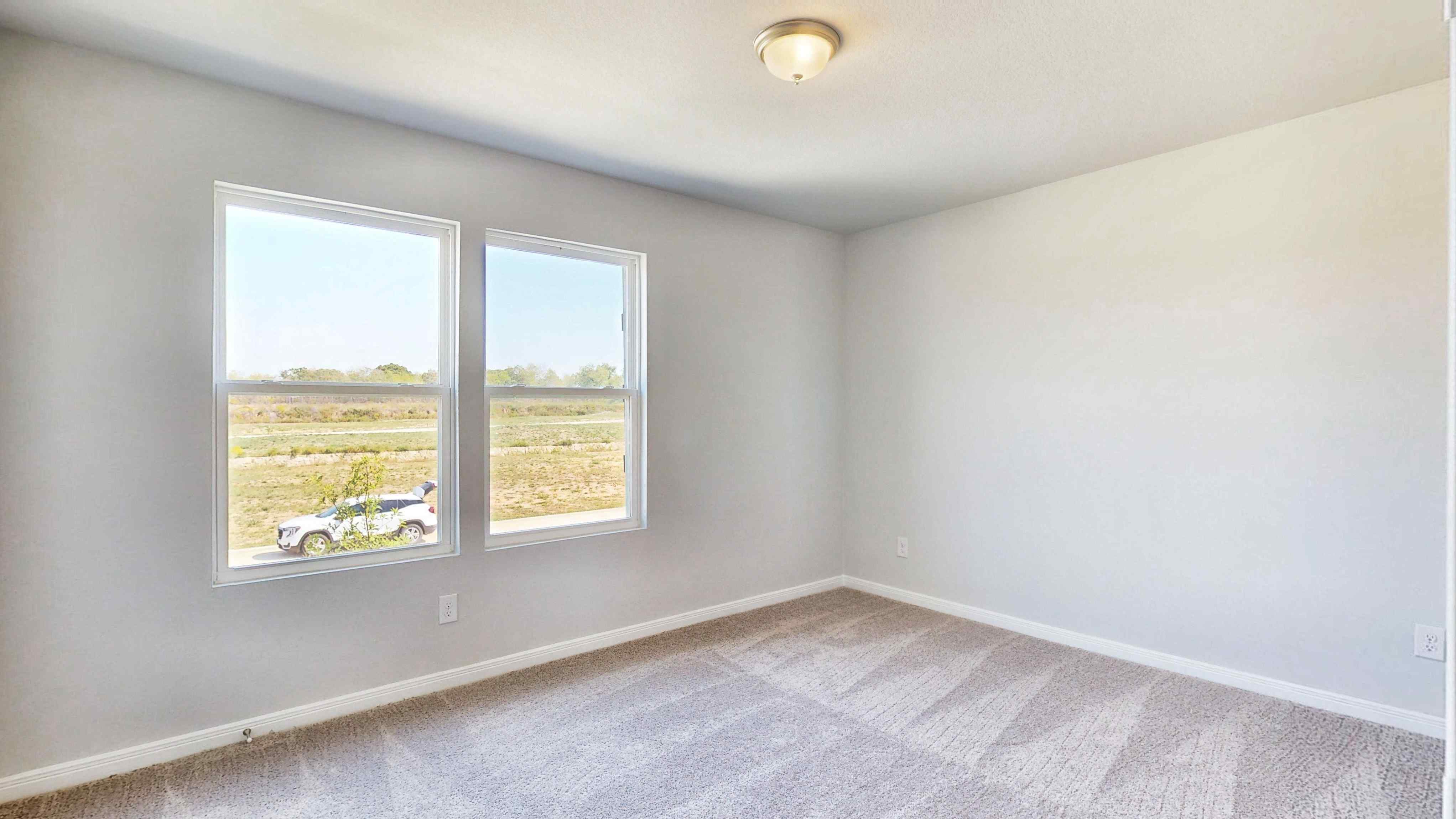 A room with a window and a car parked in it.