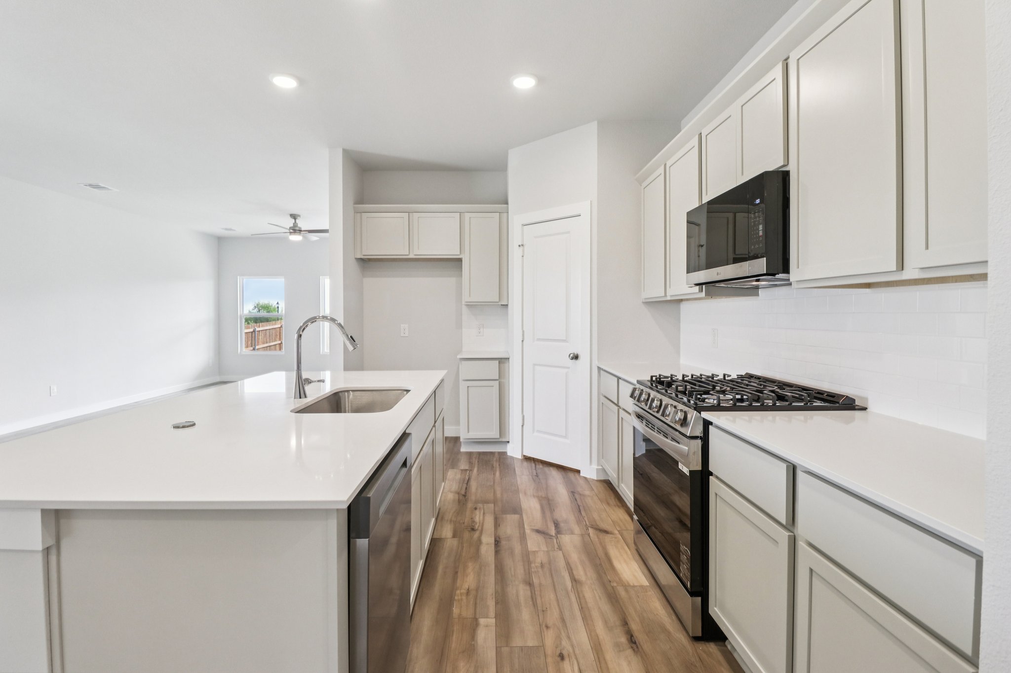 A kitchen with white cabinets.