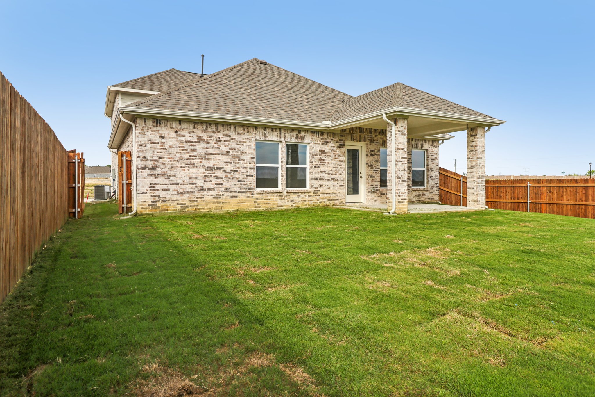 A house with a grass yard.