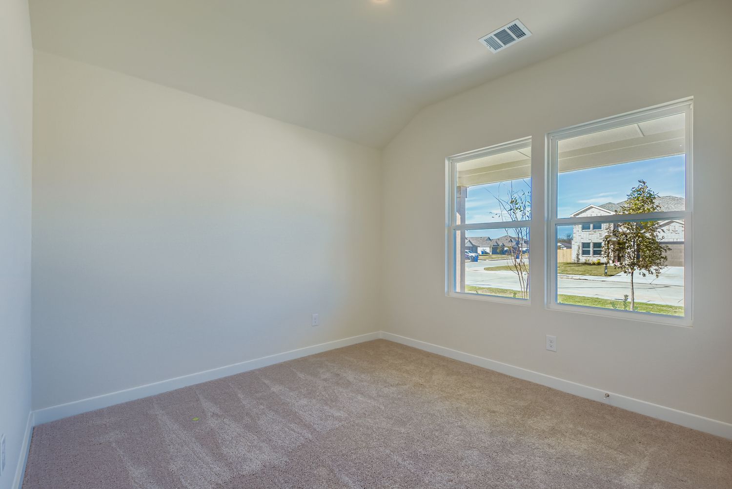 A room with a window and a carpet.