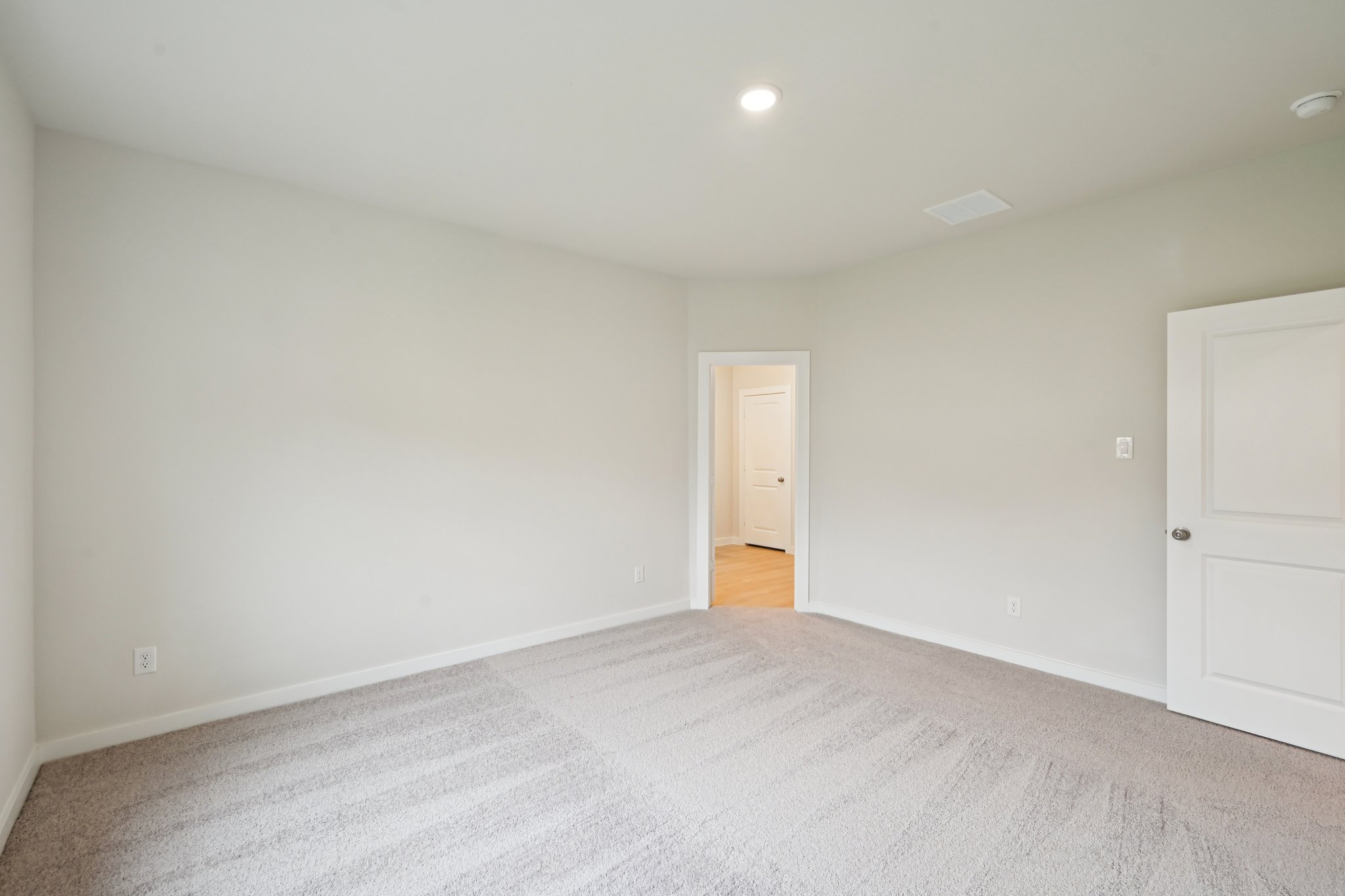 A room with white walls and a carpeted floor.