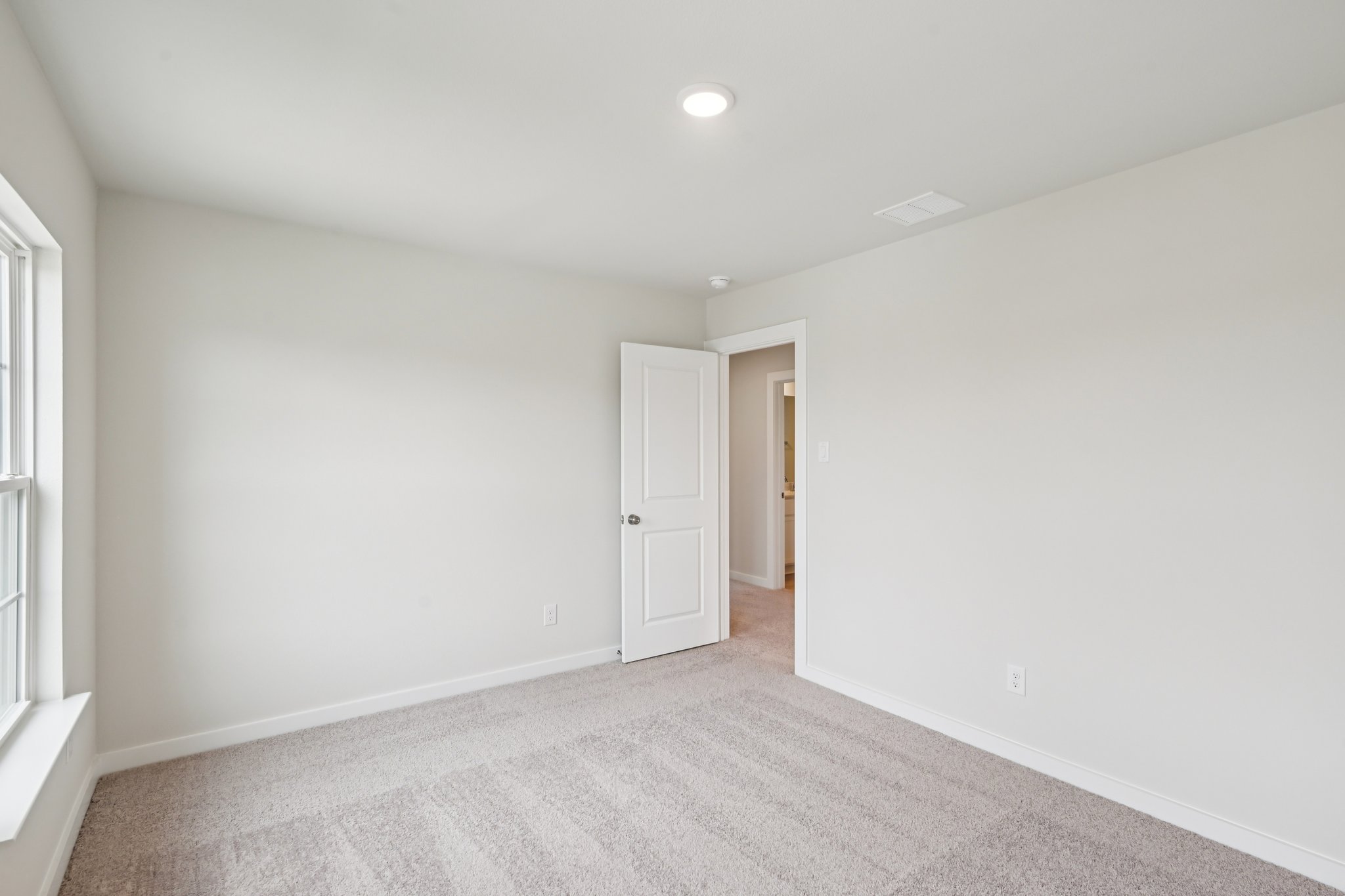 A hallway with white walls.
