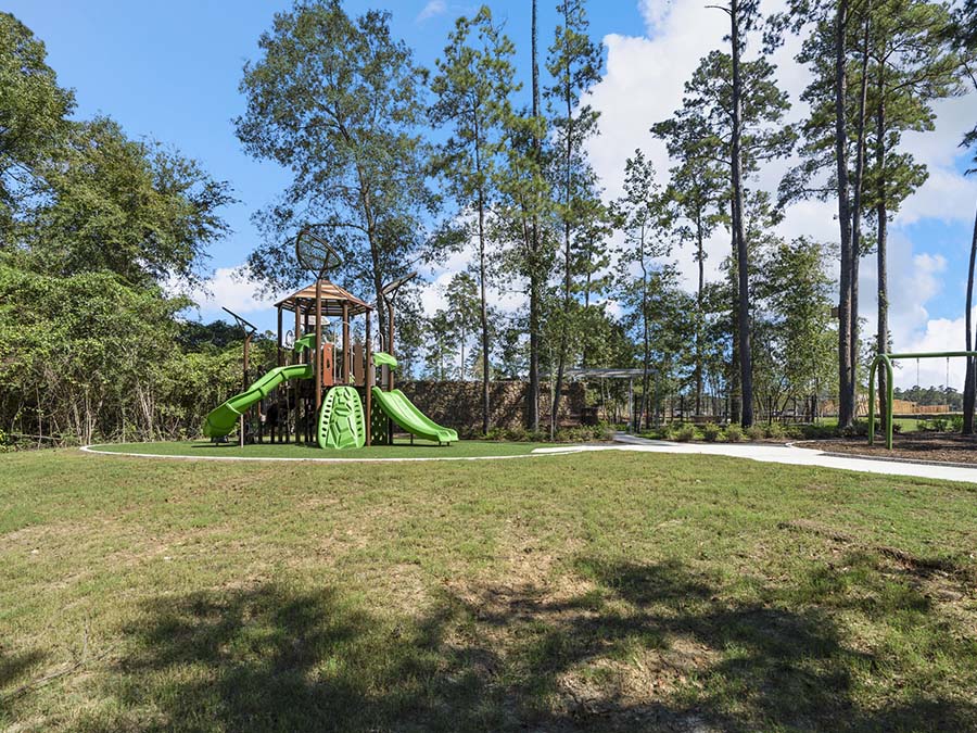 A large green slide in a park.