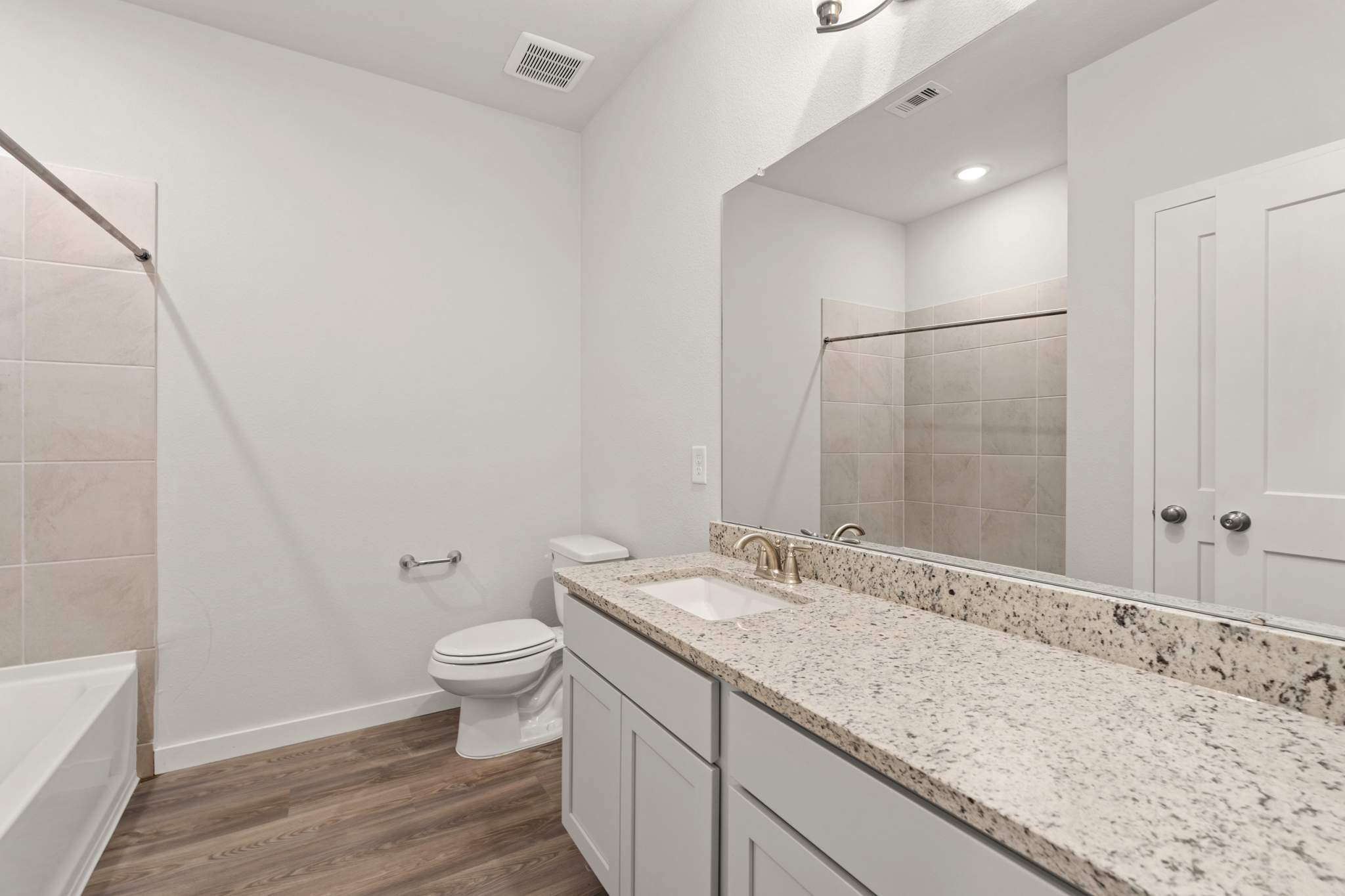 A bathroom with a marble countertop.