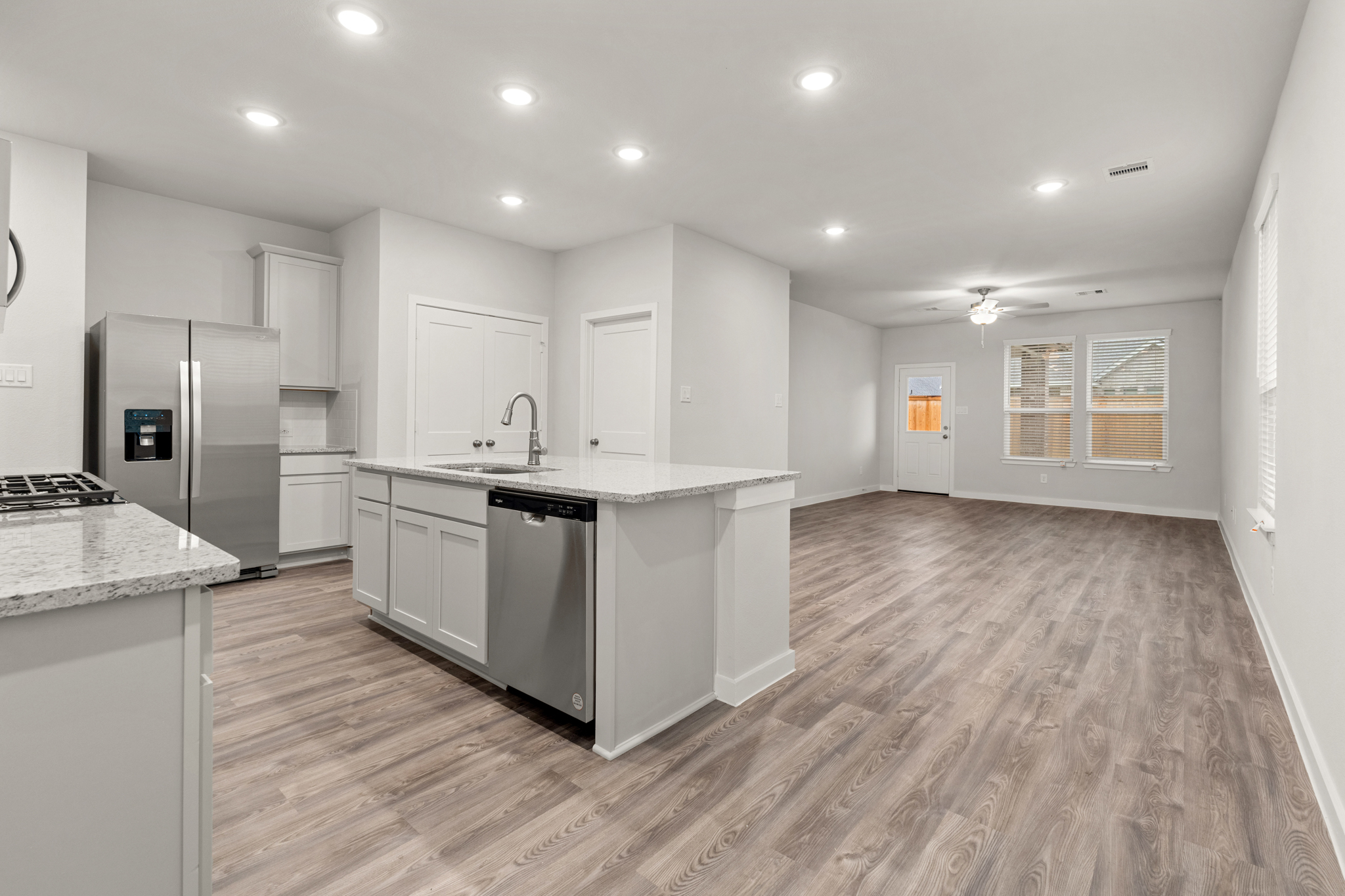 A kitchen with white cabinets.