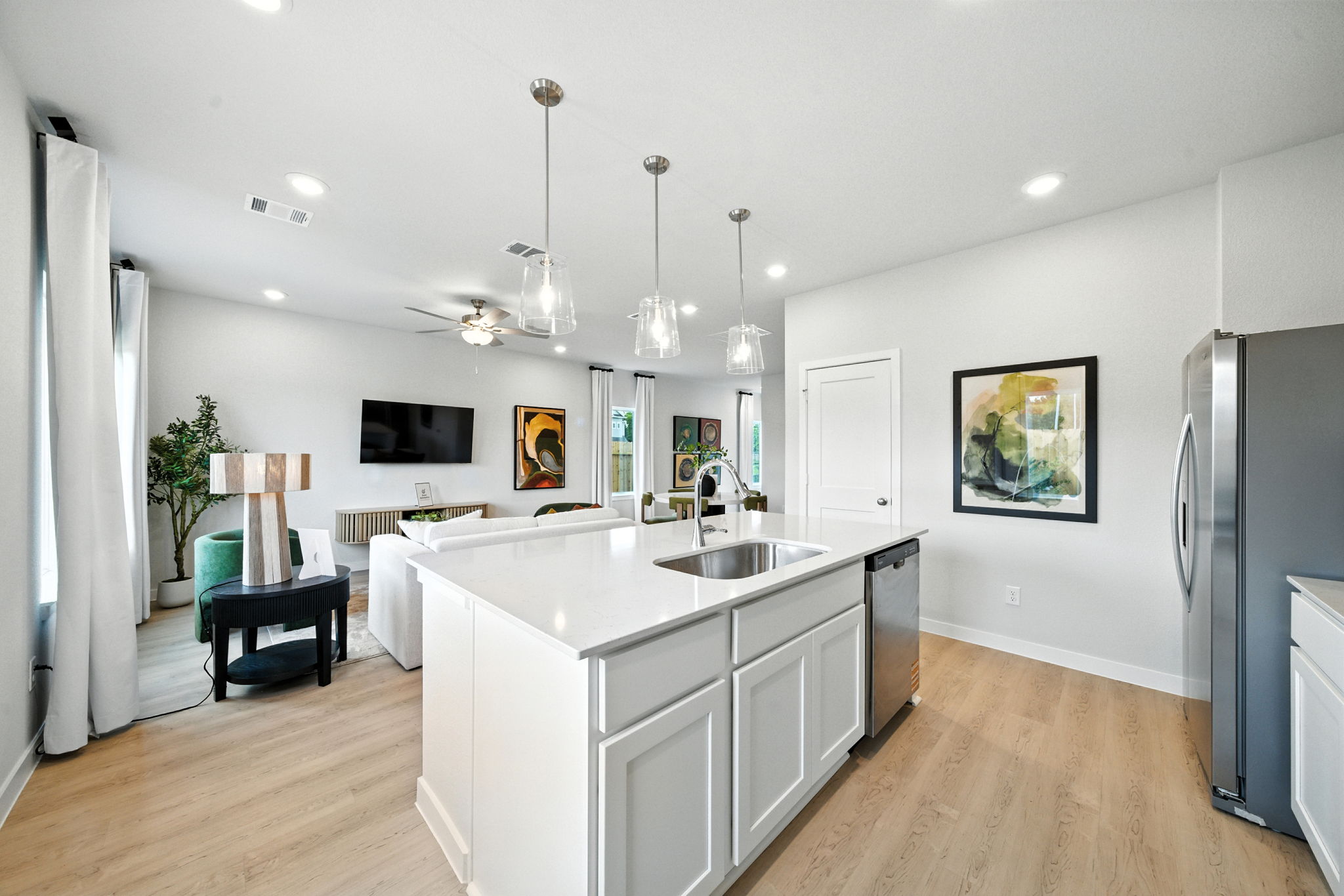 A kitchen with white cabinets.