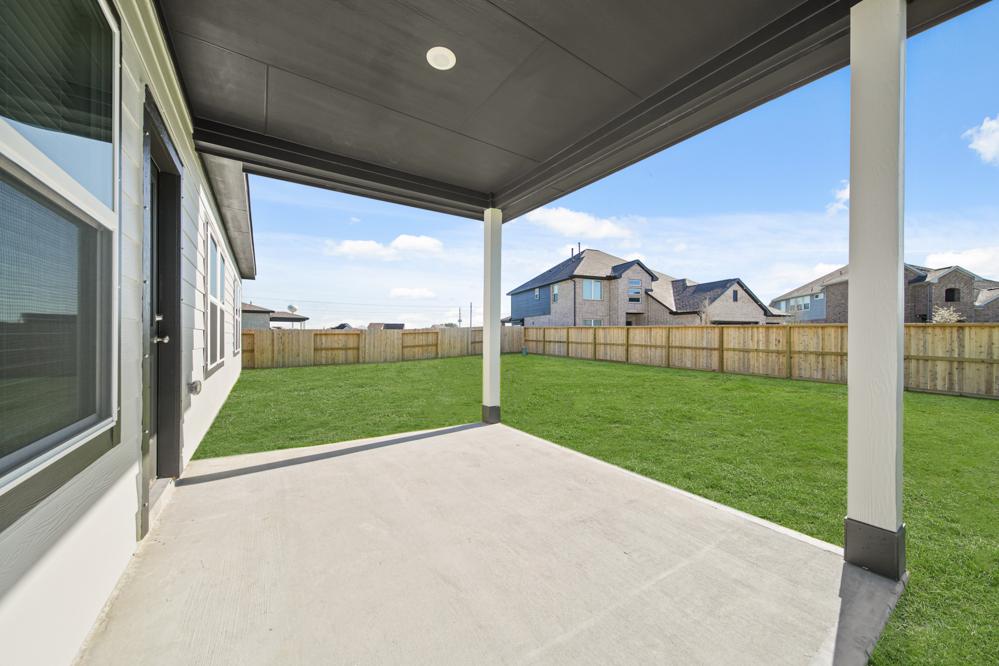 A walkway with grass and buildings.