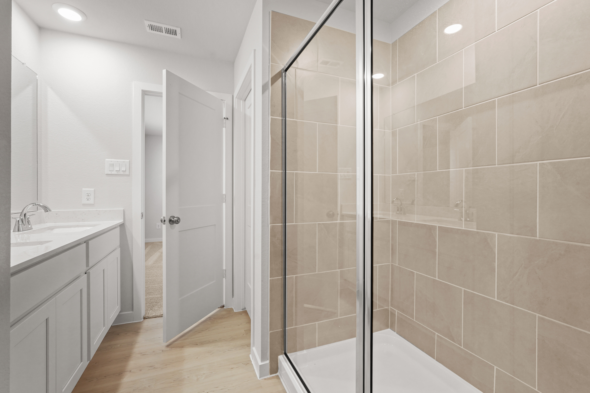A bathroom with a glass shower.