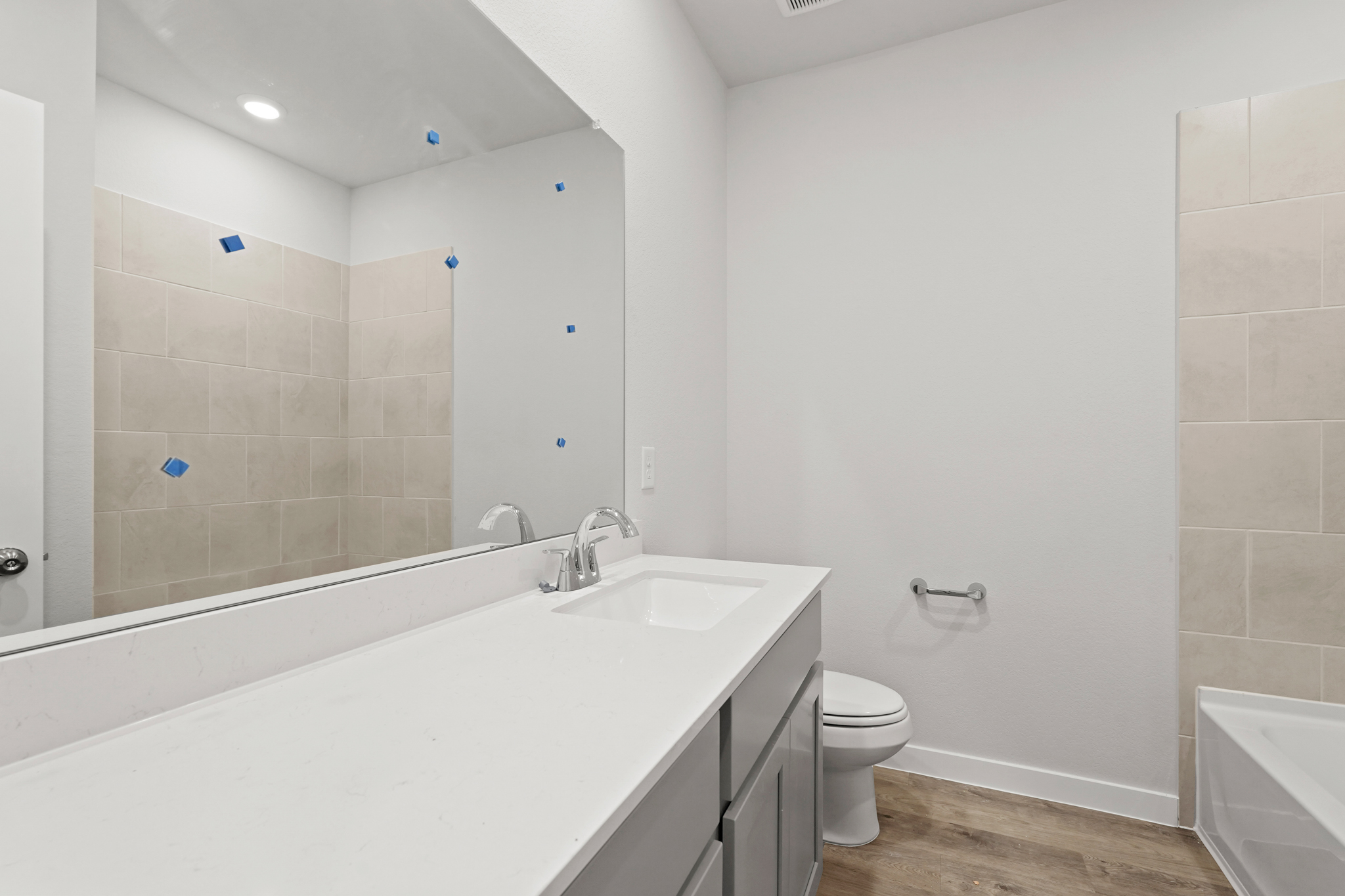 A bathroom with a tub toilet and sink.