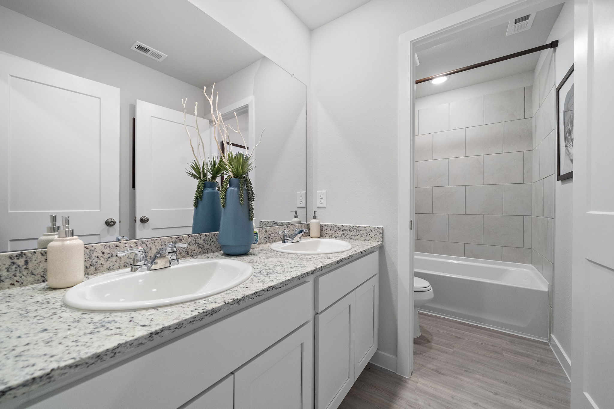 A bathroom with a large mirror.