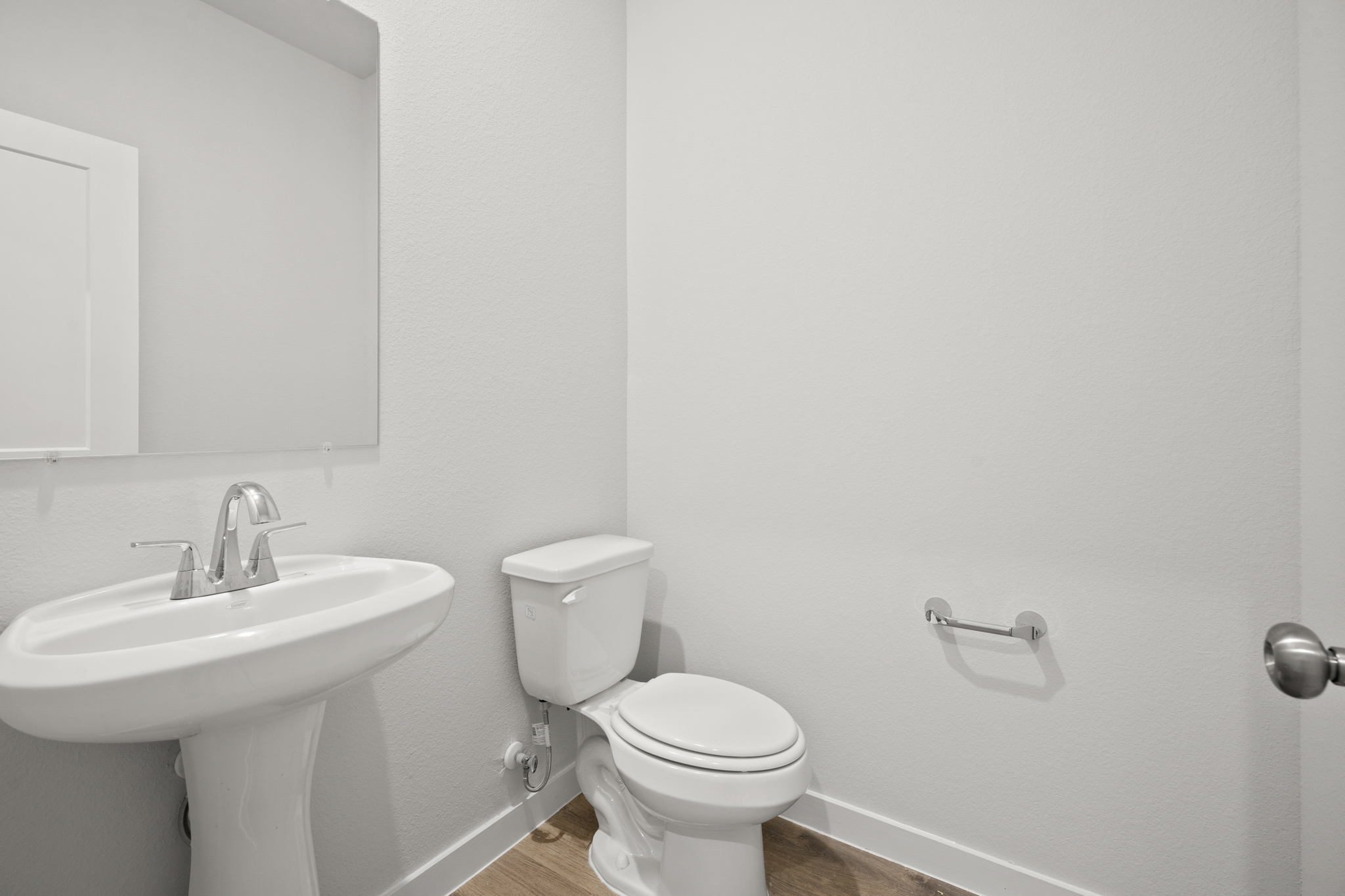 A bathroom with a toilet and sink.