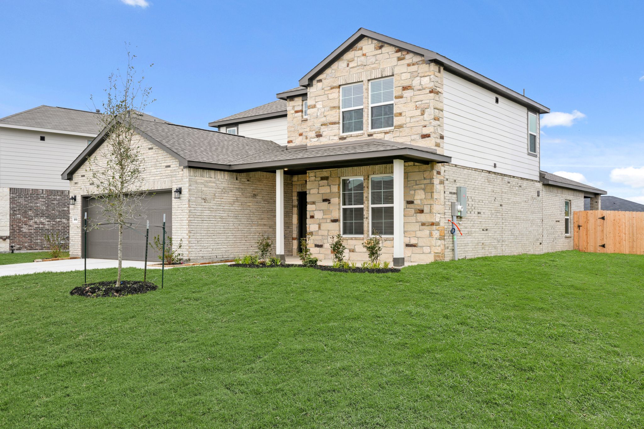 A house with a lawn in front.