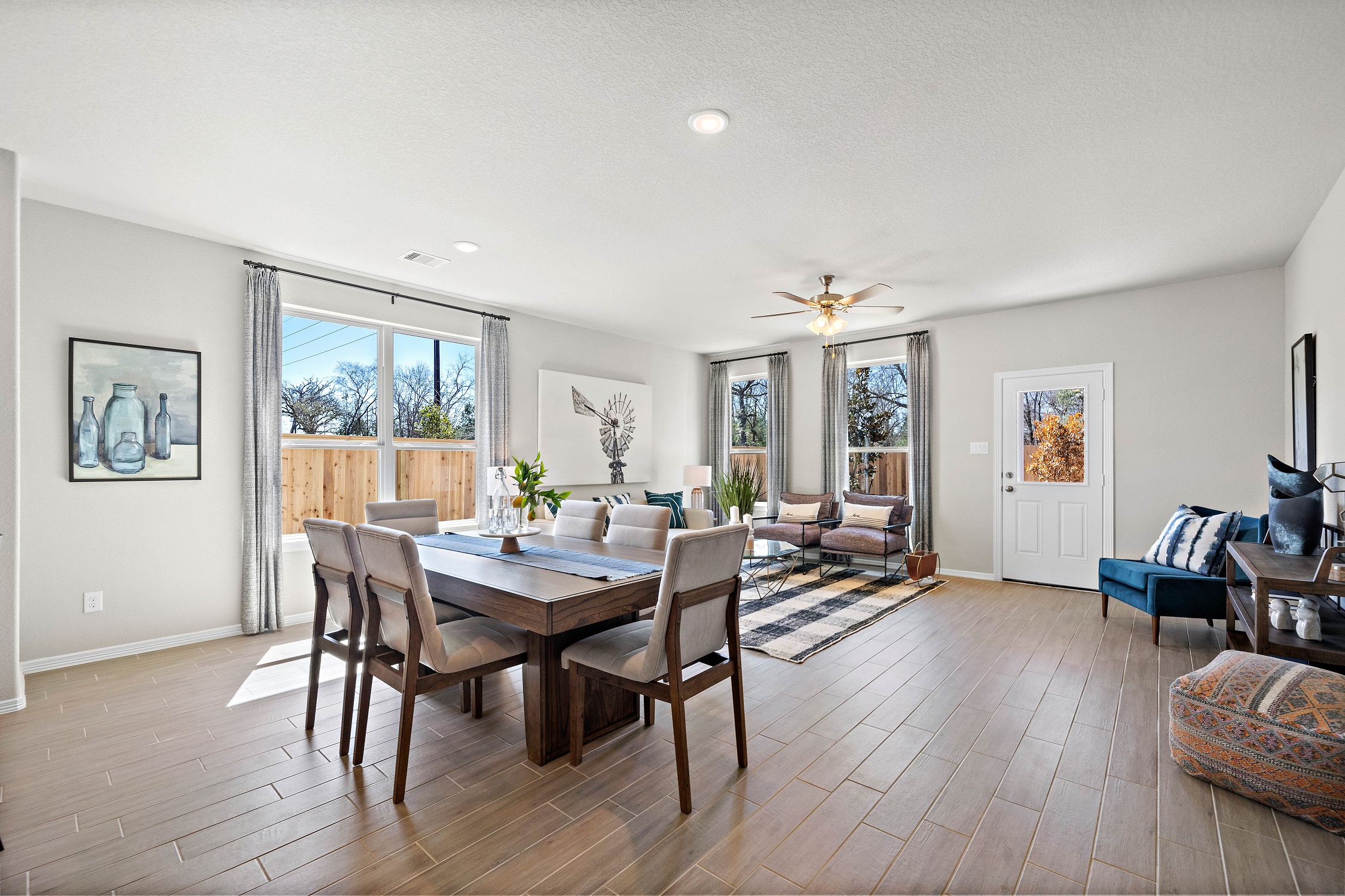 A dining room with a wood floor.