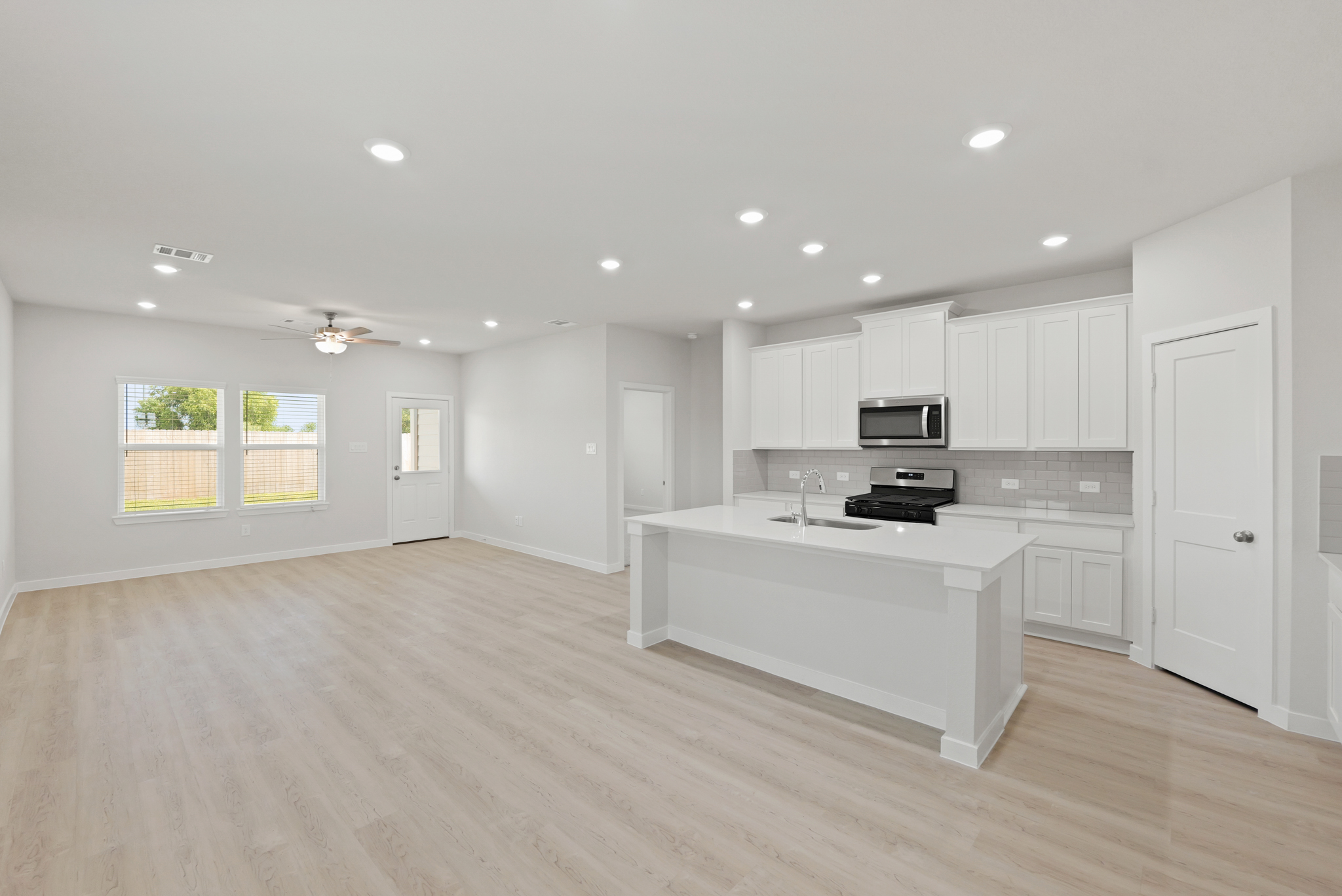 A kitchen with white cabinets.