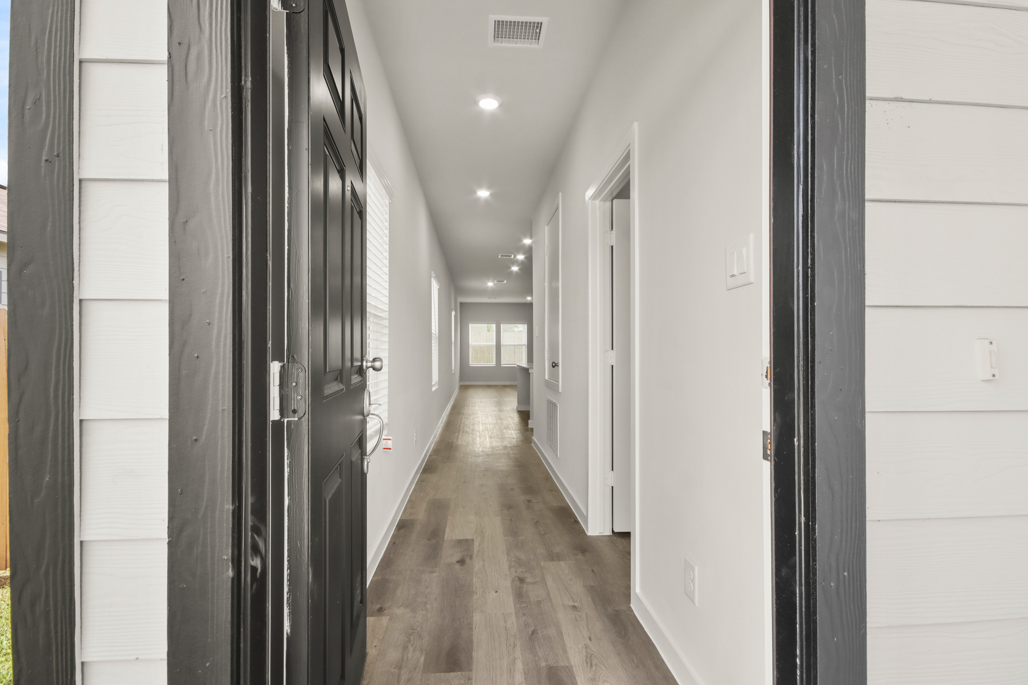 A hallway with white doors.