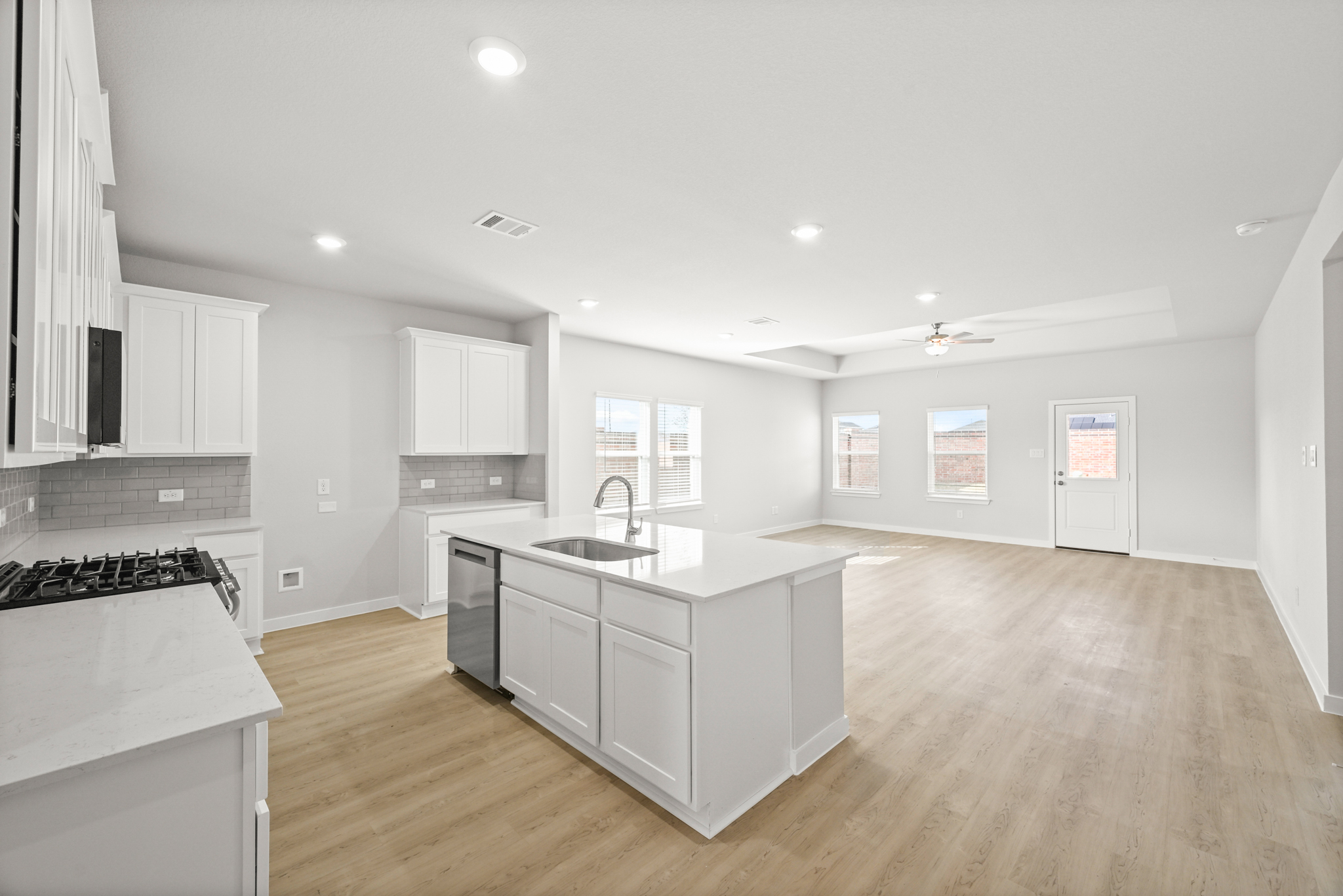 A large kitchen with white cabinets.