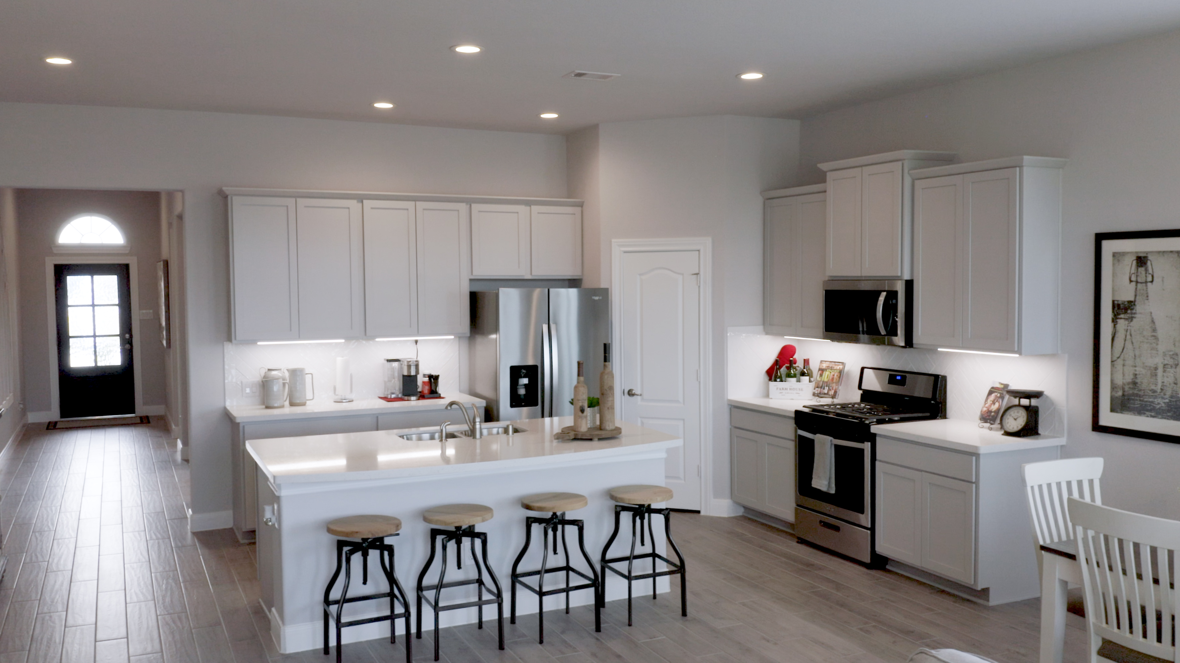 A kitchen with white cabinets.