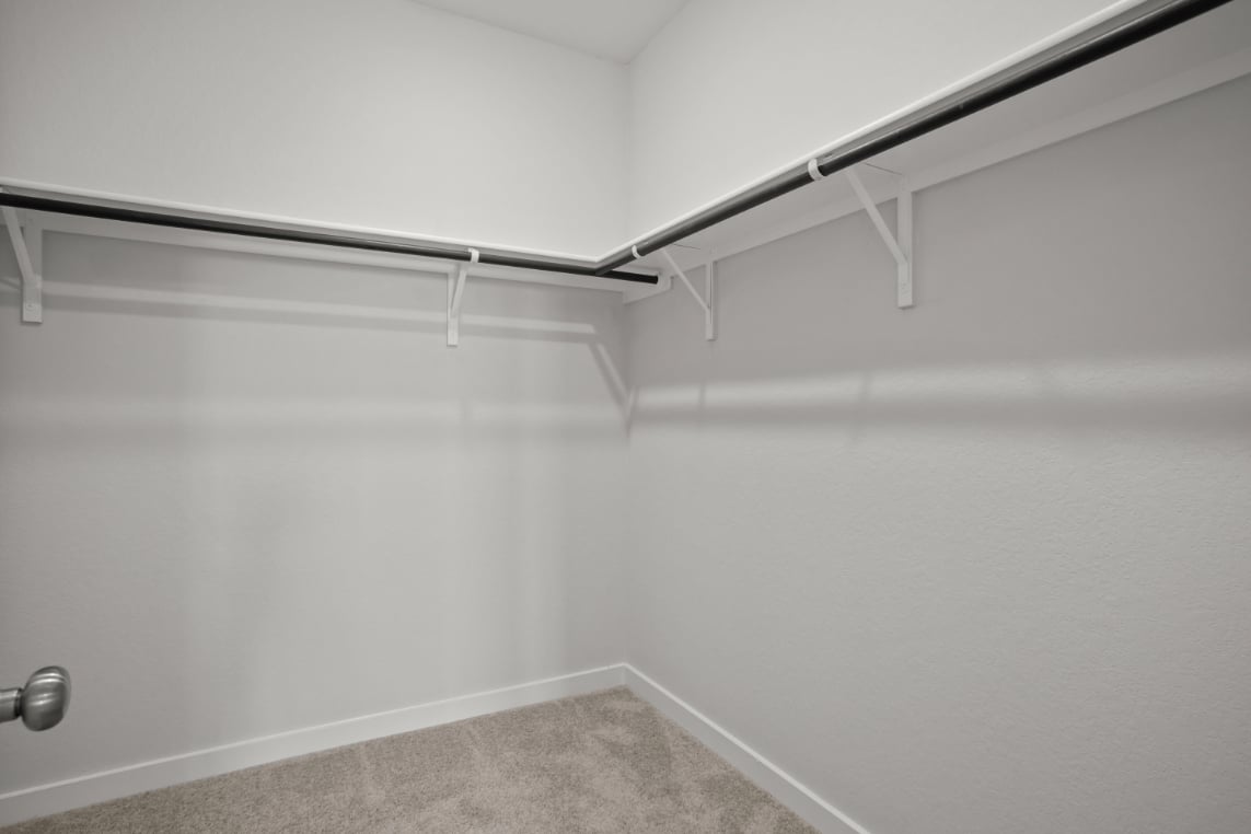 A white wall with a metal railing.