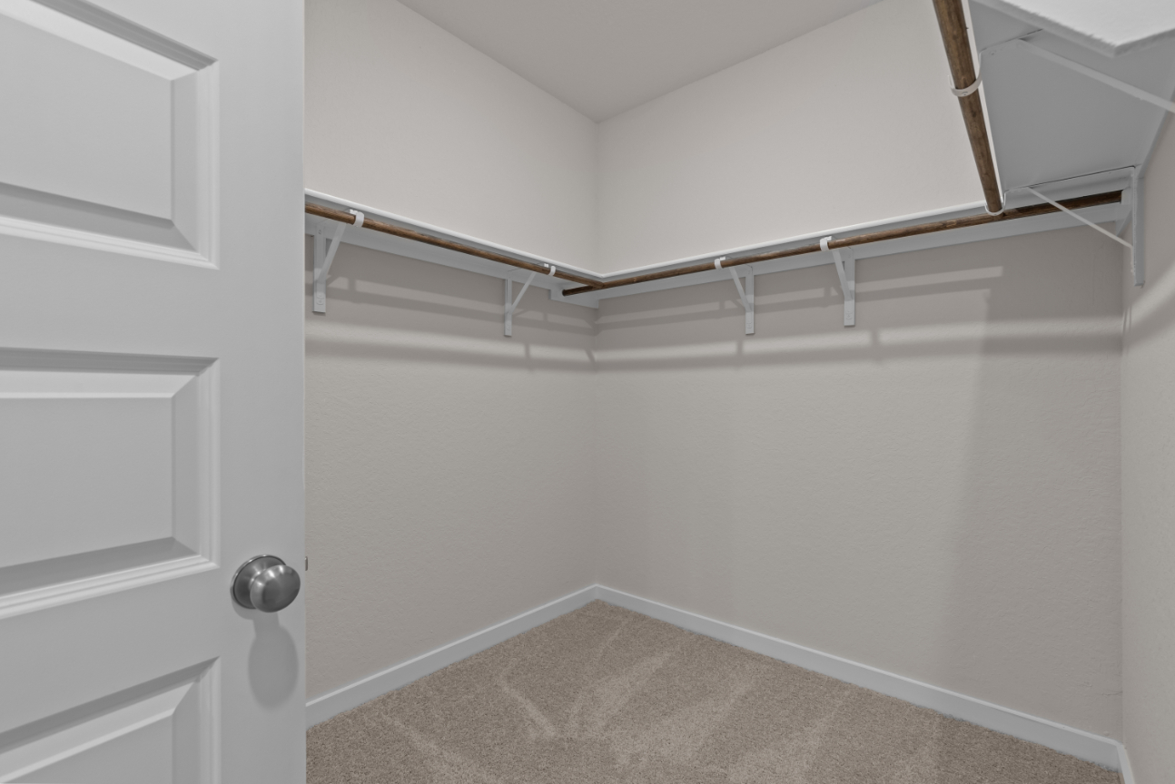 A white wall with a metal bar.