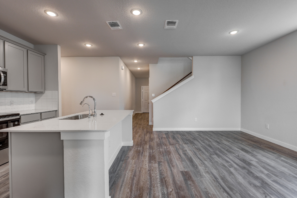 A kitchen with a wood floor.