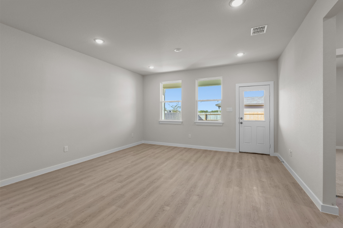 A room with a wood floor and white walls.