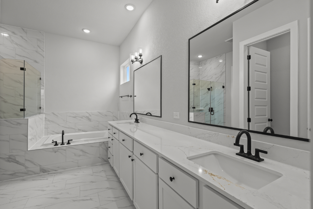 A bathroom with a large mirror.