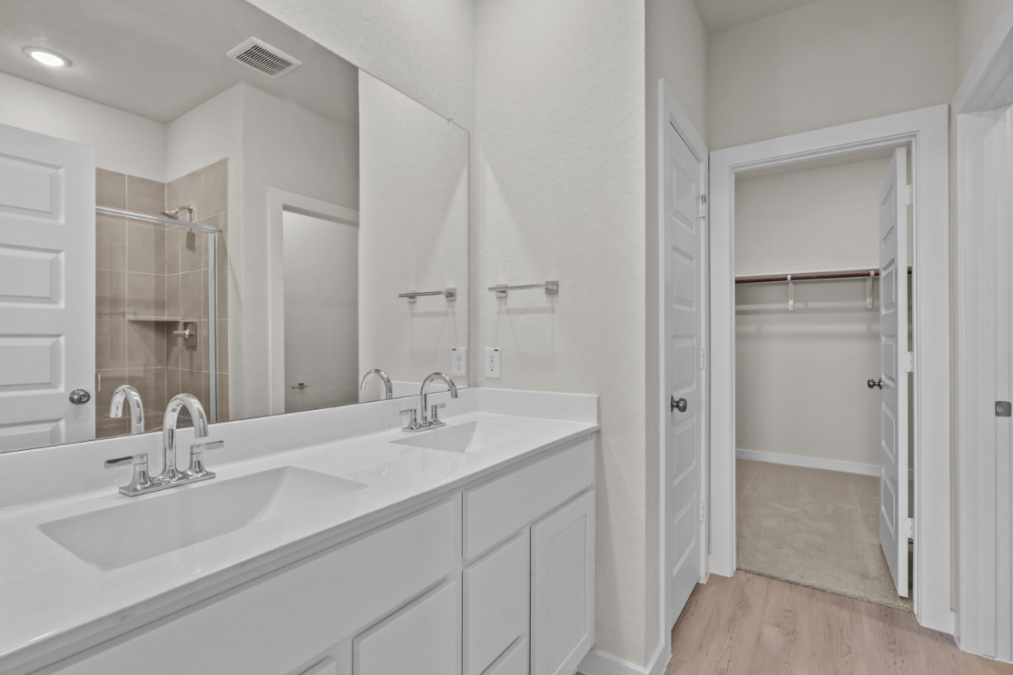 A bathroom with a sink and shower.