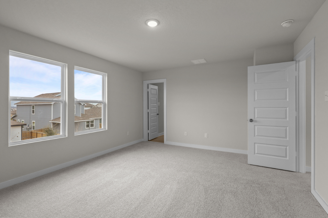 A room with white walls and a window.