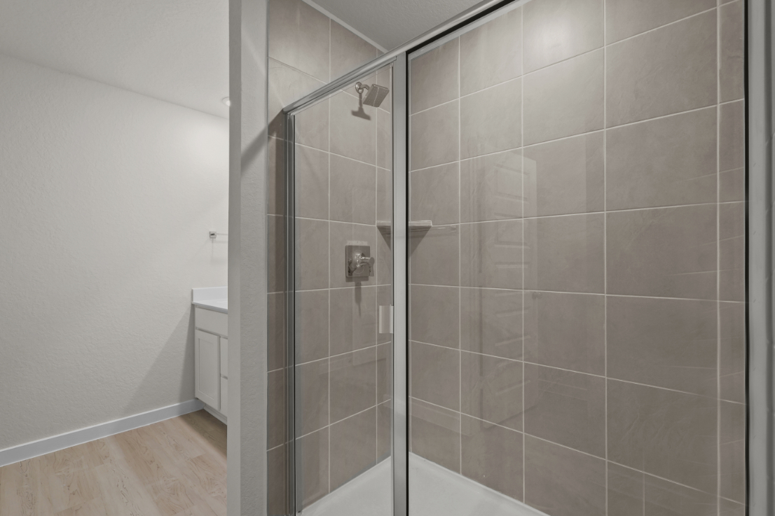 A shower with a glass door.