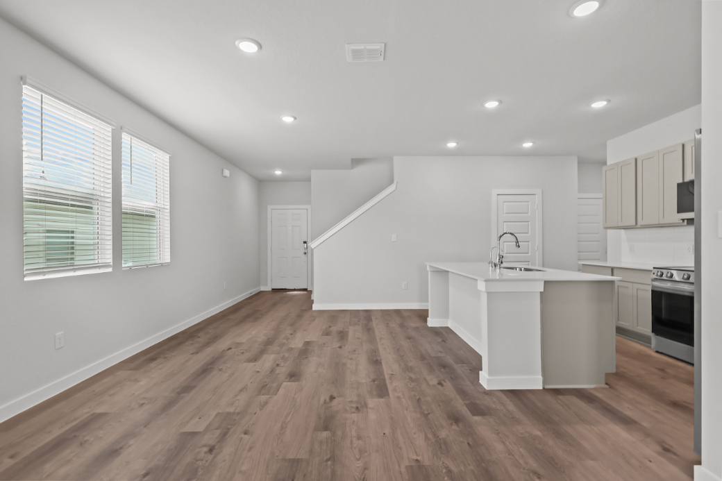 A kitchen with white cabinets.