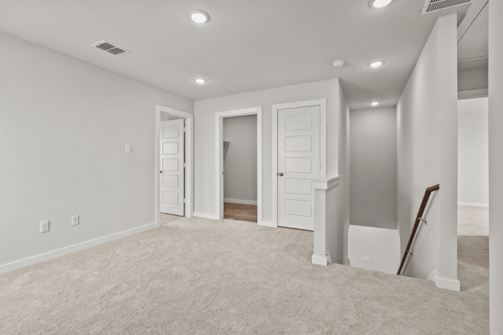 A room with white walls and a staircase.