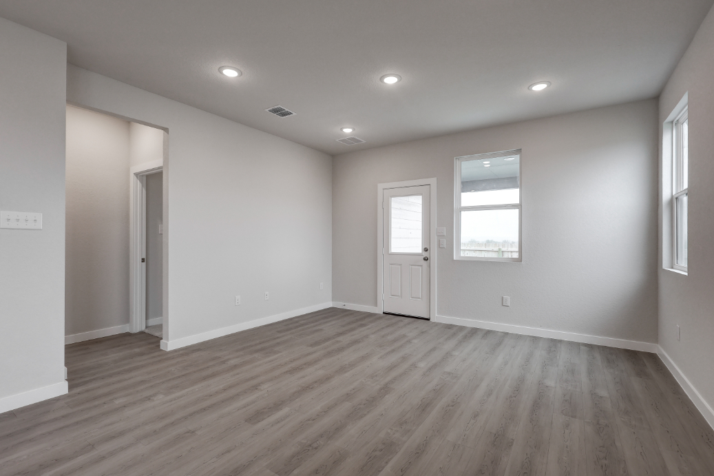 A room with white walls and a wood floor.