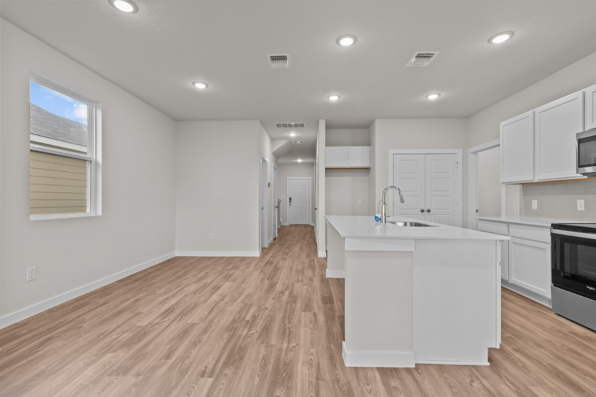 A kitchen with white cabinets.