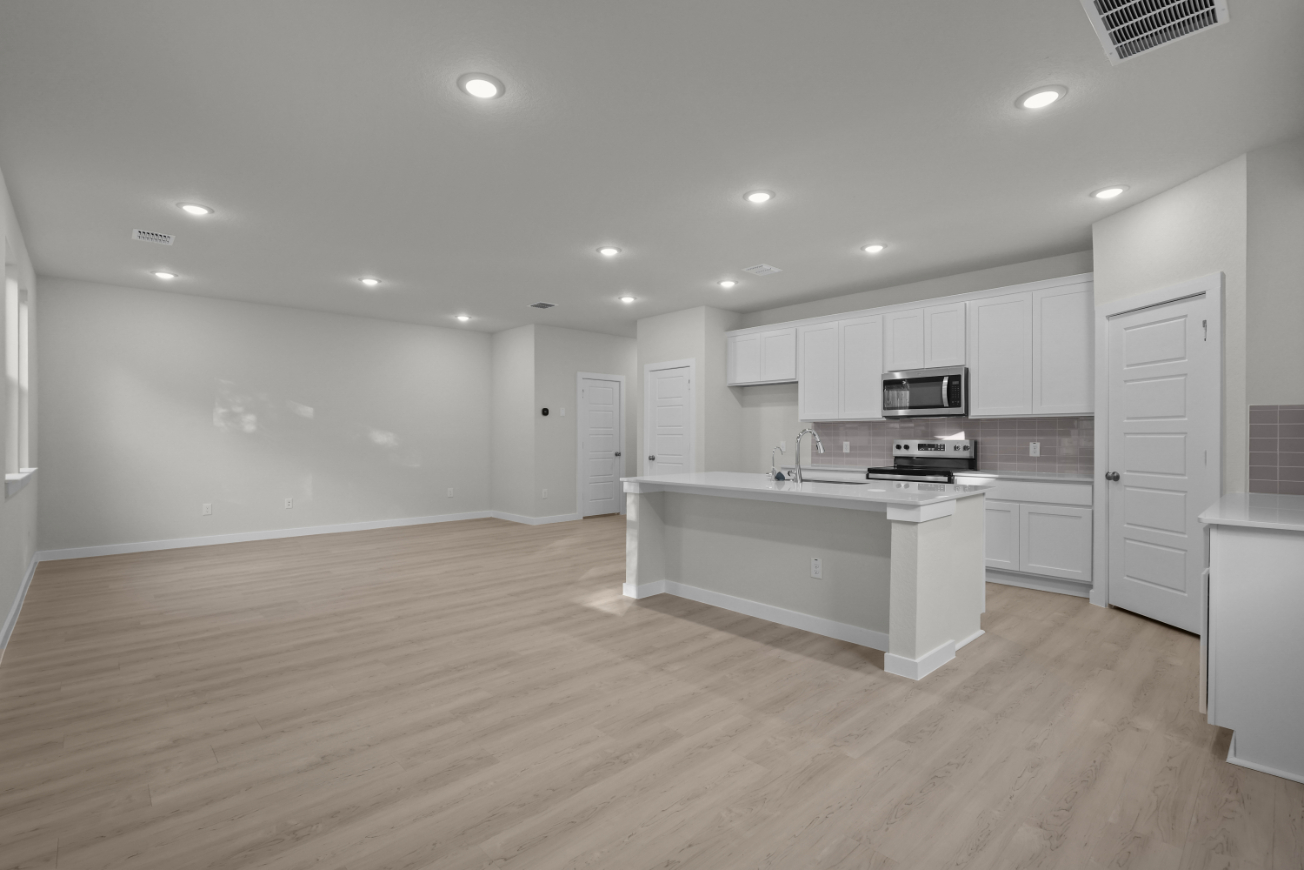 A large kitchen with white cabinets.