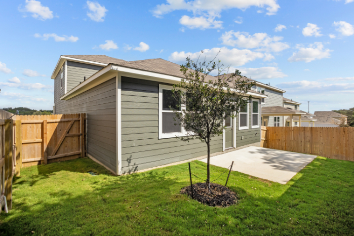 A house with a tree in the front yard.