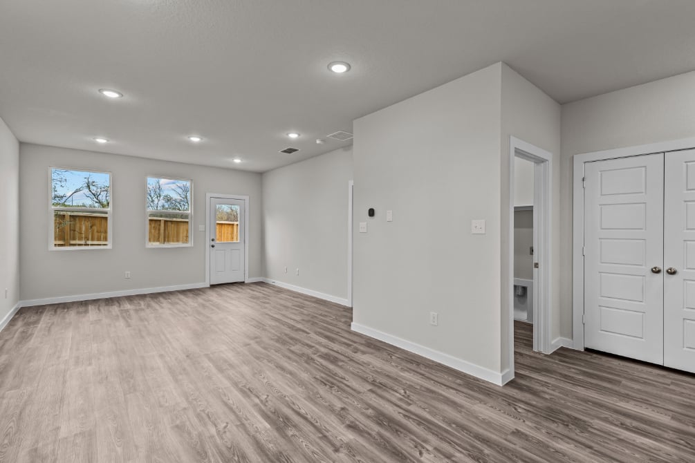 A room with white walls and a wood floor.